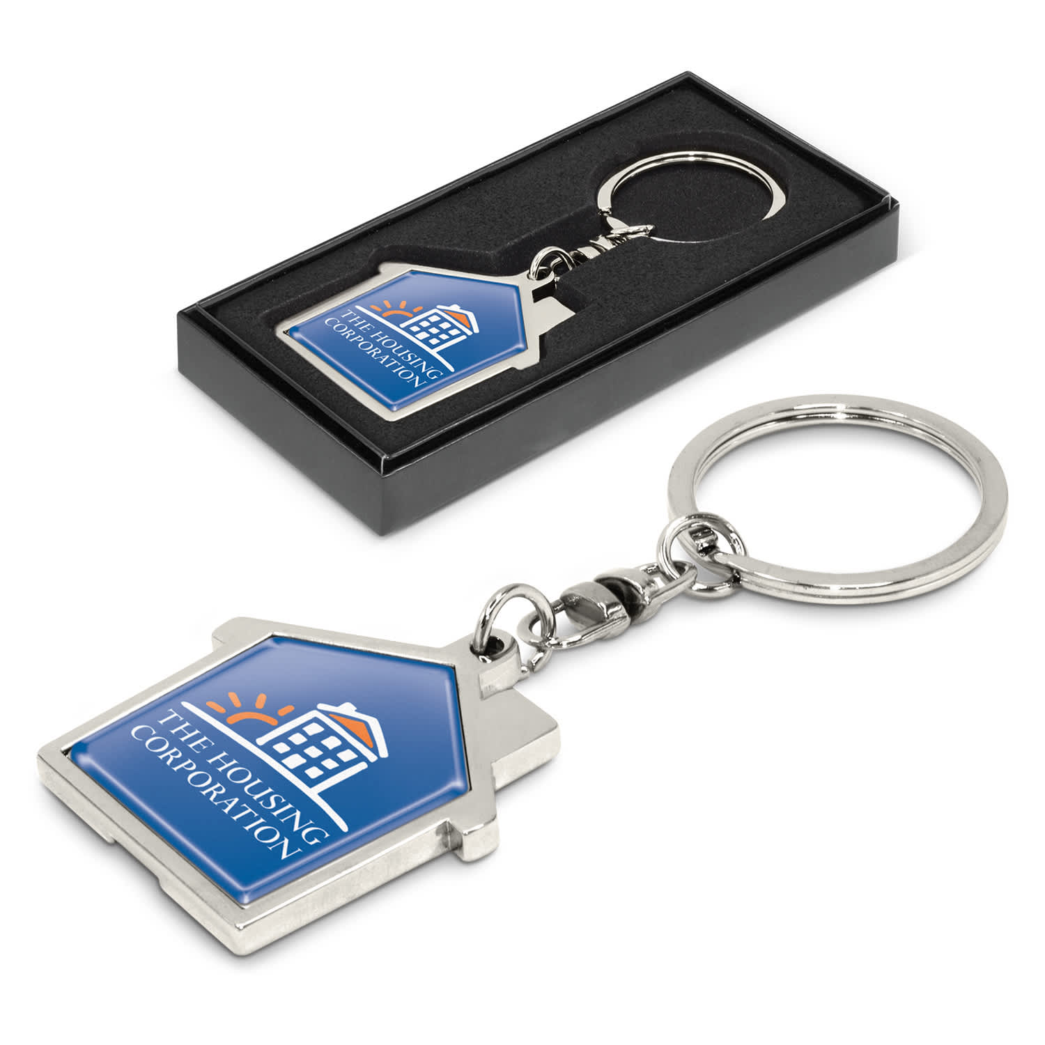A house-shaped metal key ring in silver with a blue and white logo on a black presentation box. House Metal Key Ring - Image 1