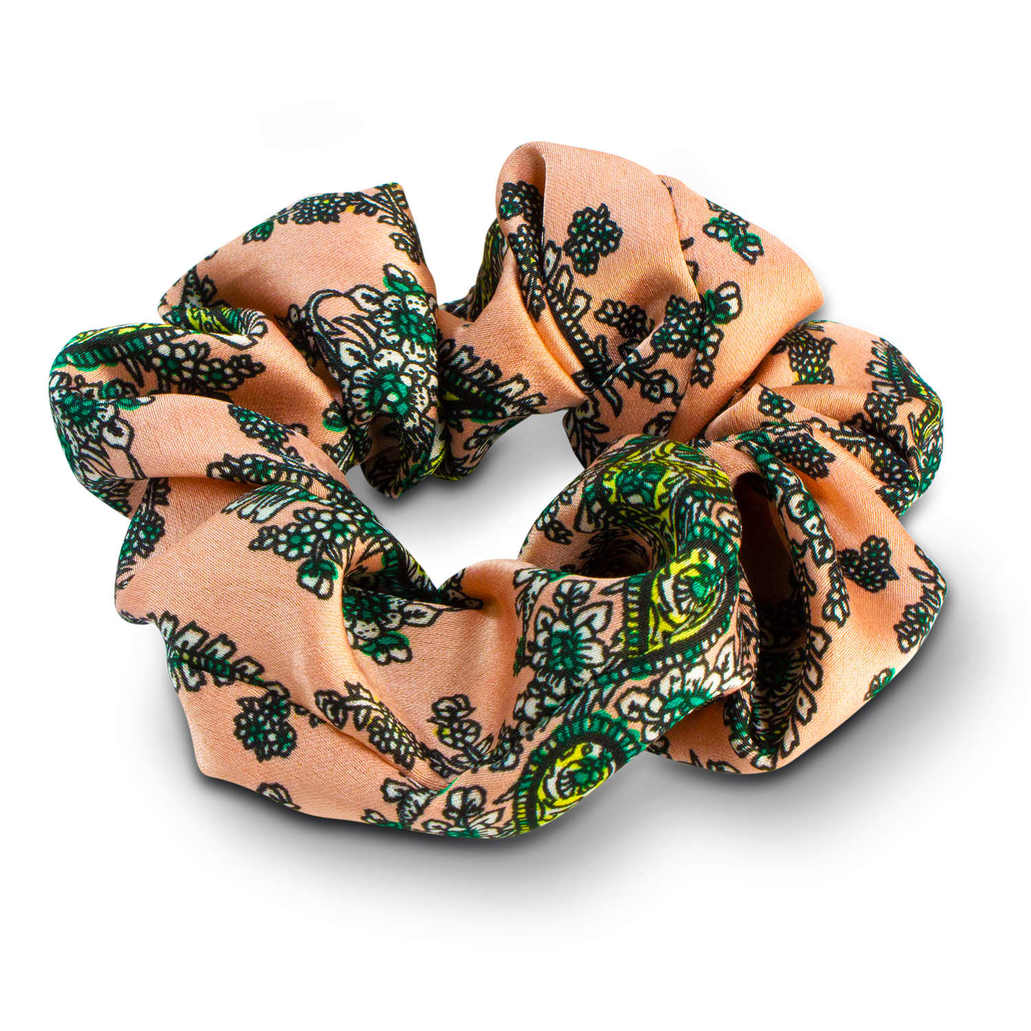 A peach patterned hair scrunchie with green floral designs, featuring a subtle sheen and a soft fabric texture. Hair Scrunchie - Image 1