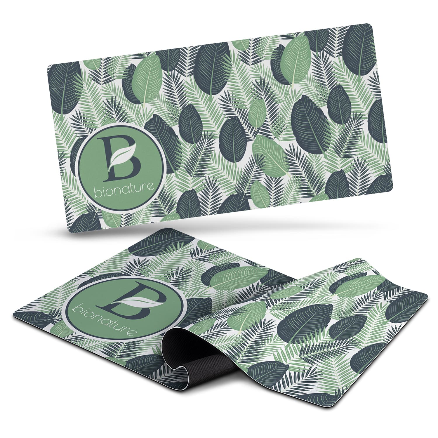 A desk mat featuring a leafy green design with various shades of green and a circular logo. Desk Mat - Image 1