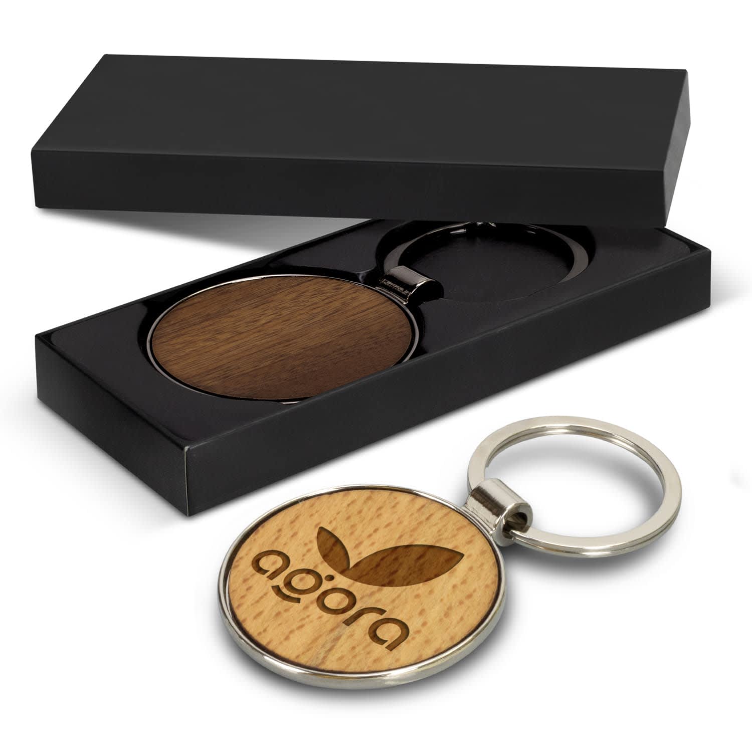 A round wooden key ring with a metallic keychain, presented in a black gift box. Santo Key Ring - Round - Image 1