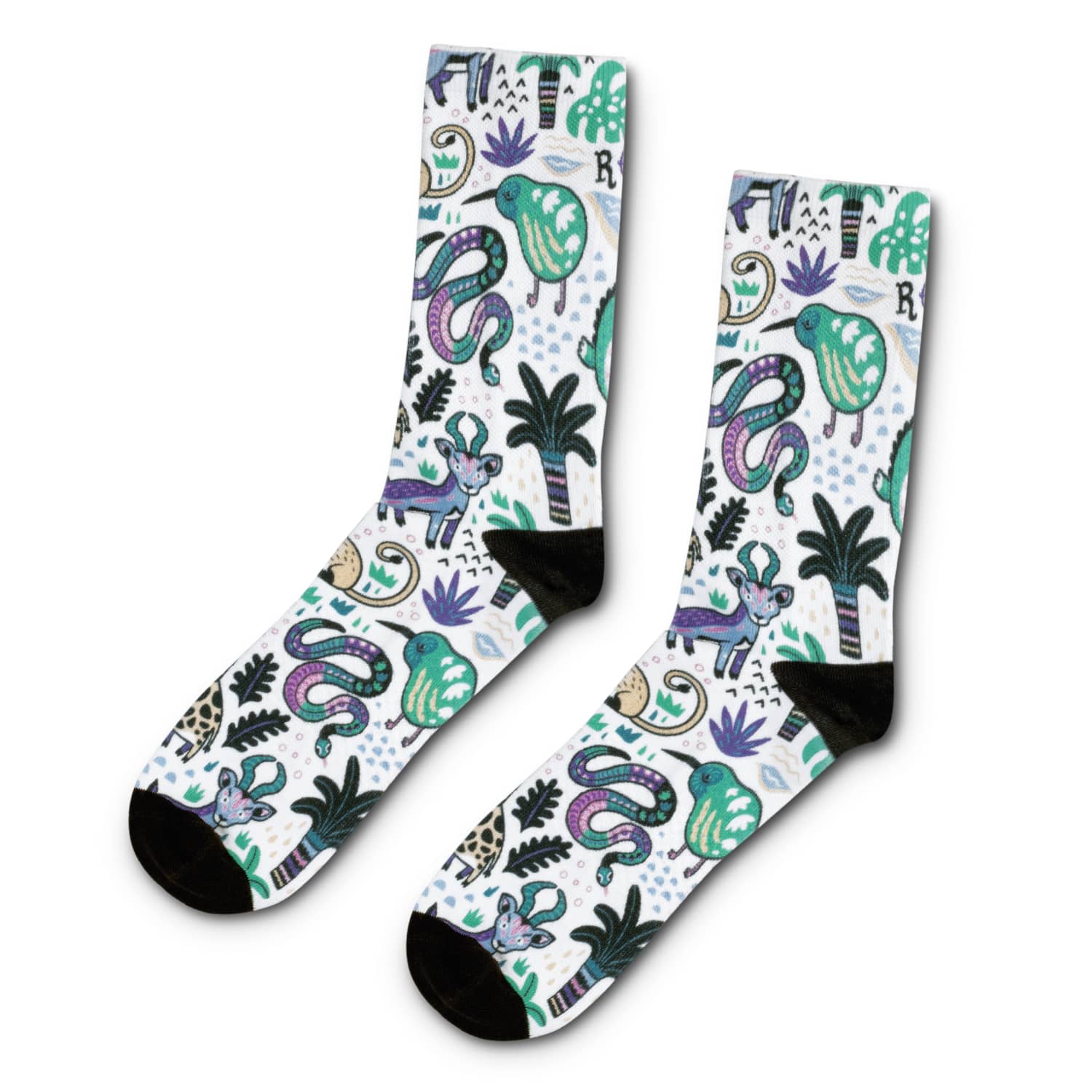 A pair of crew socks featuring a vibrant design with green, purple, and black motifs, including animals and plants. Mojo Crew Sock - Image 1