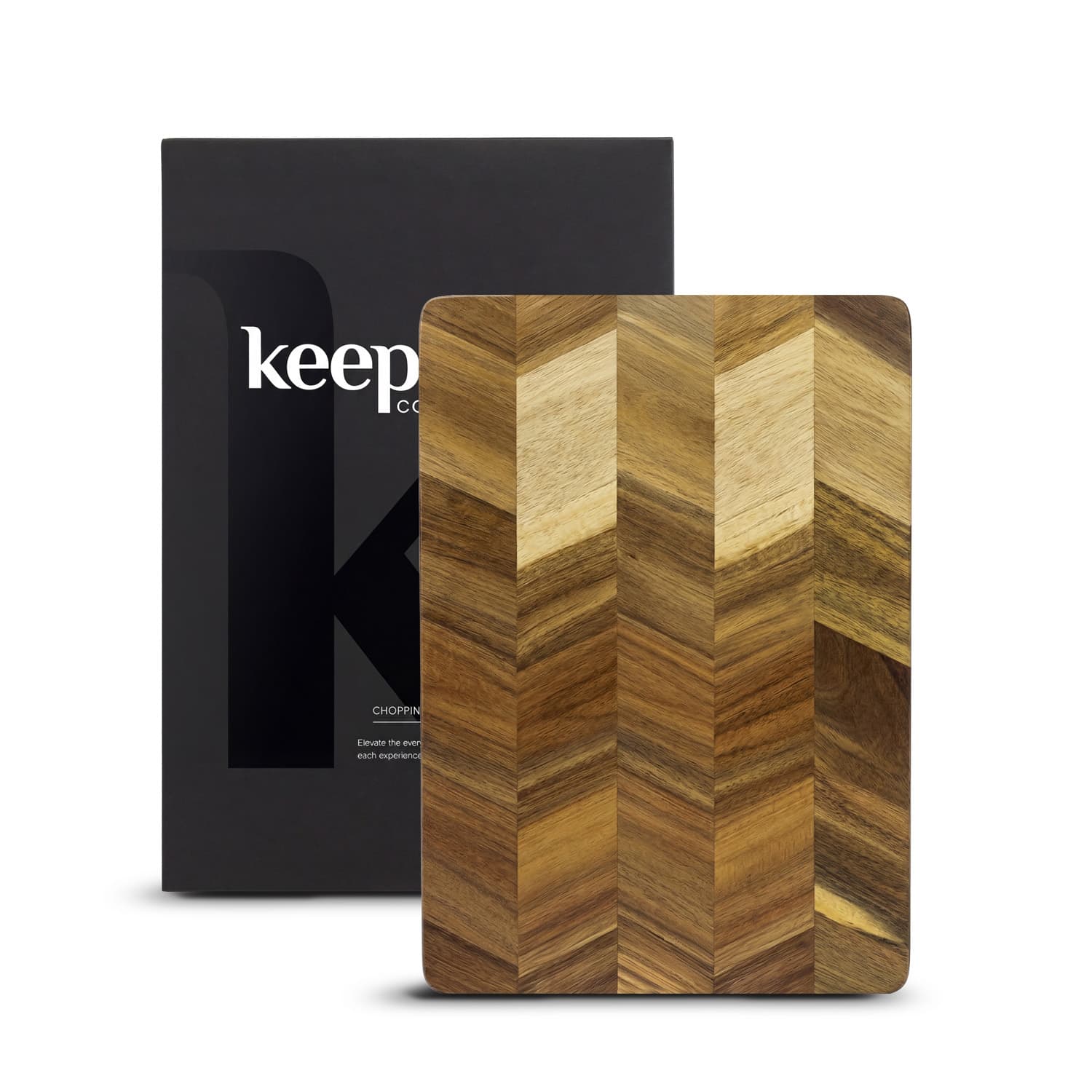 A wooden chopping board with a chevron pattern, packaged in a branded box. Keepsake Chopping Board - Image 1
