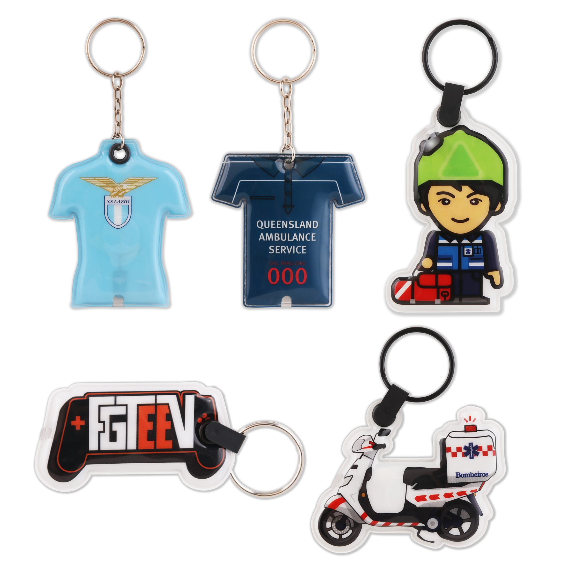 A PVC LED keyring set featuring a shirt, ambulance, character, game controller, and scooter design in various colours. PVC LED Keyring - Image 1