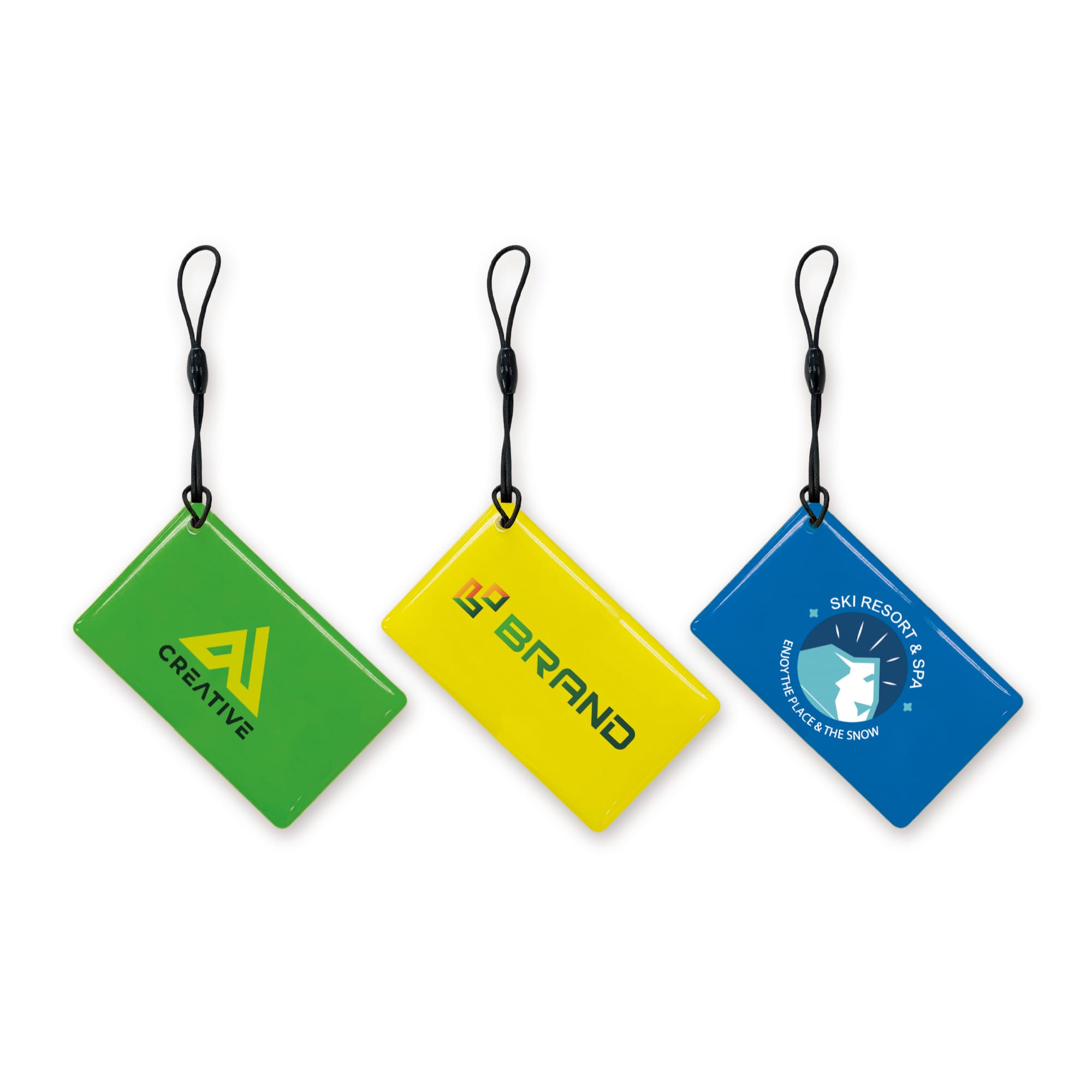 Three NFC epoxy square tags in green, yellow, and a third tag featuring a logo, all with a loop for attachment. NFC Epoxy Square Tag - Image 1