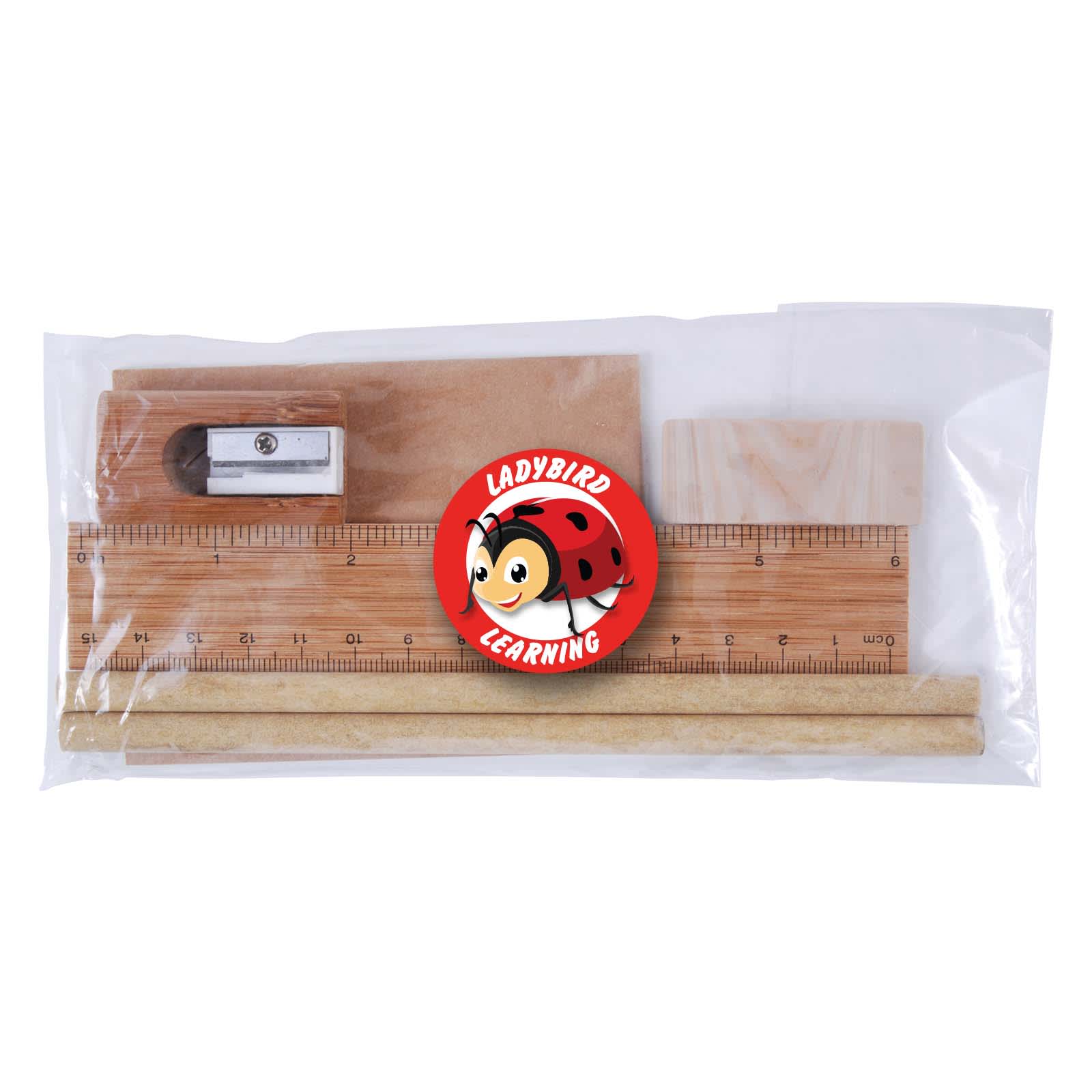 A clear package containing a wooden ruler, two wooden sticks, a sharpener, and an eraser featuring a cartoon character. Yale Stationery Set - Image 1