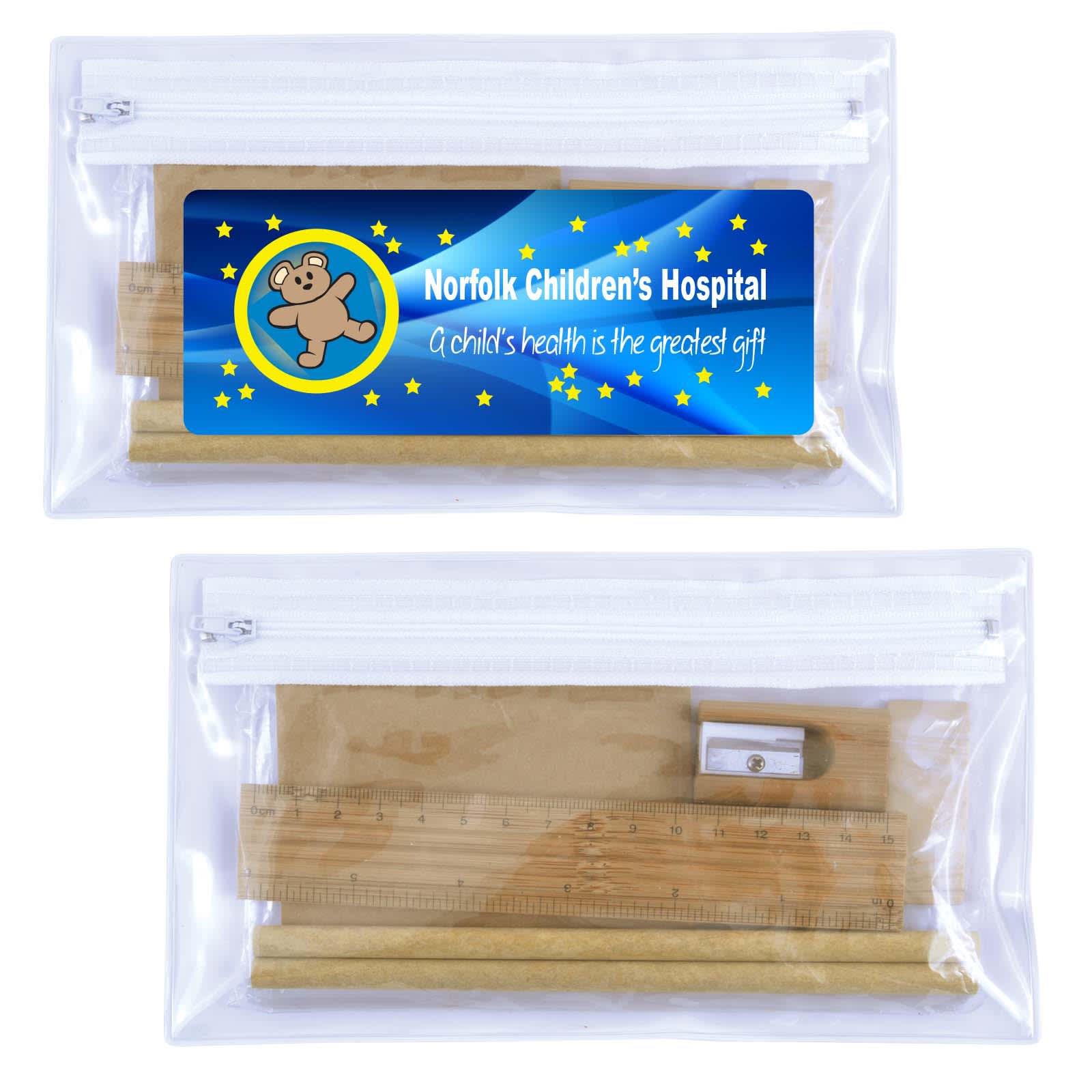 A clear pencil case containing a yellow ruler, a sharpener, and additional stationery items. It features a logo. Stanford Stationery Set - Image 1