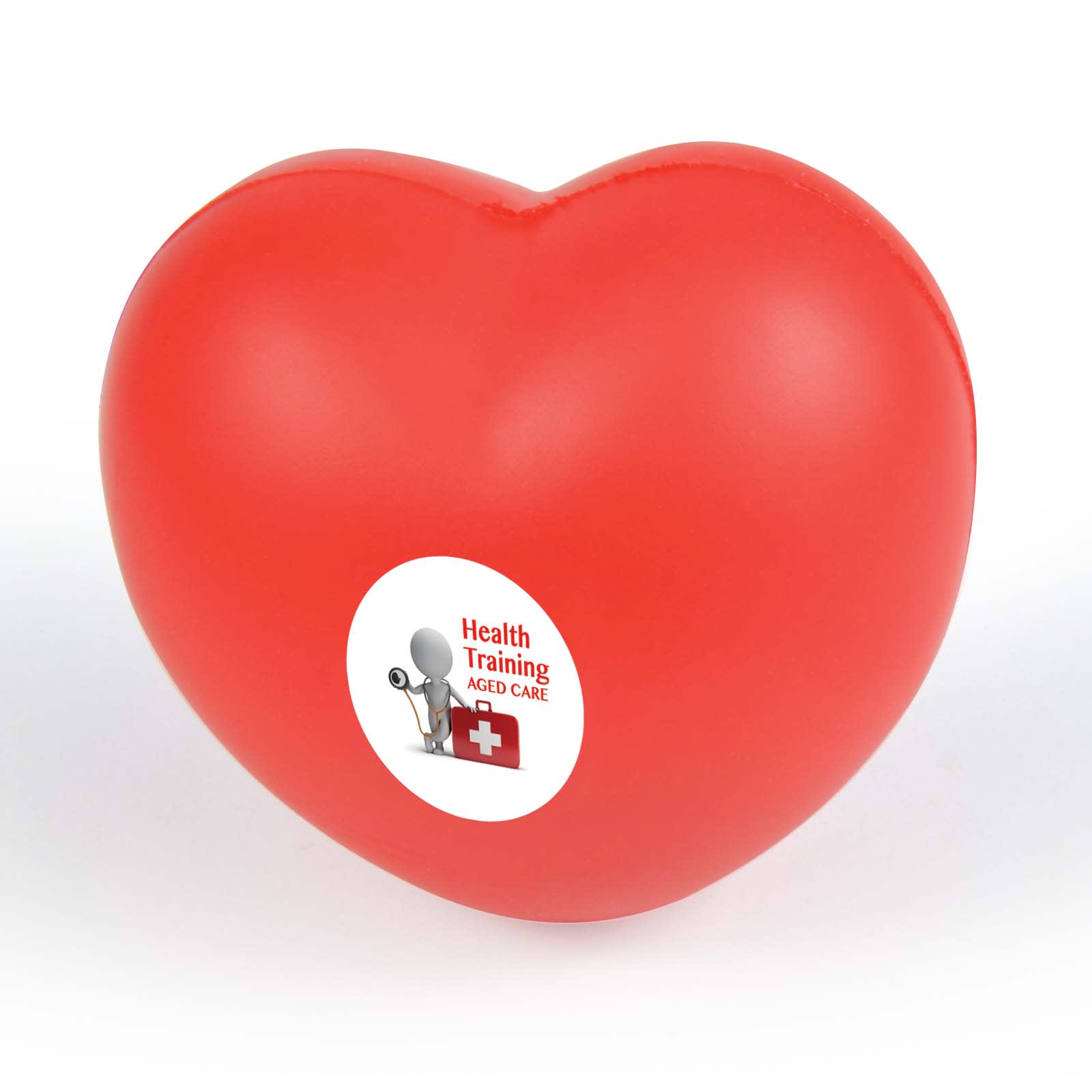 A red heart-shaped stress reliever with a circular label featuring the text "Health Training Aged Care." Heart Stress Reliever - Image 1