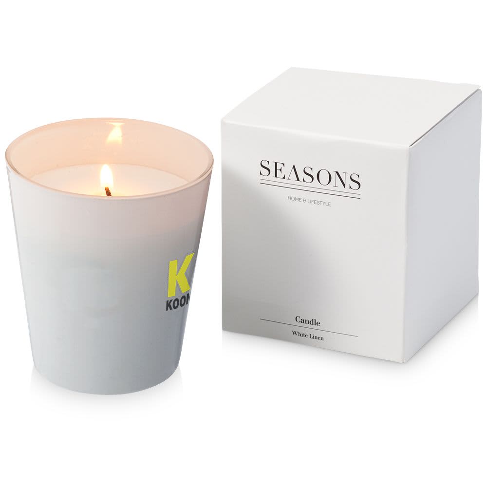 A grey scented candle in a frosted glass holder, accompanied by a white box. The candle is burning, revealing a soft glow. Seasons Lunar Scented Candle - Image 1