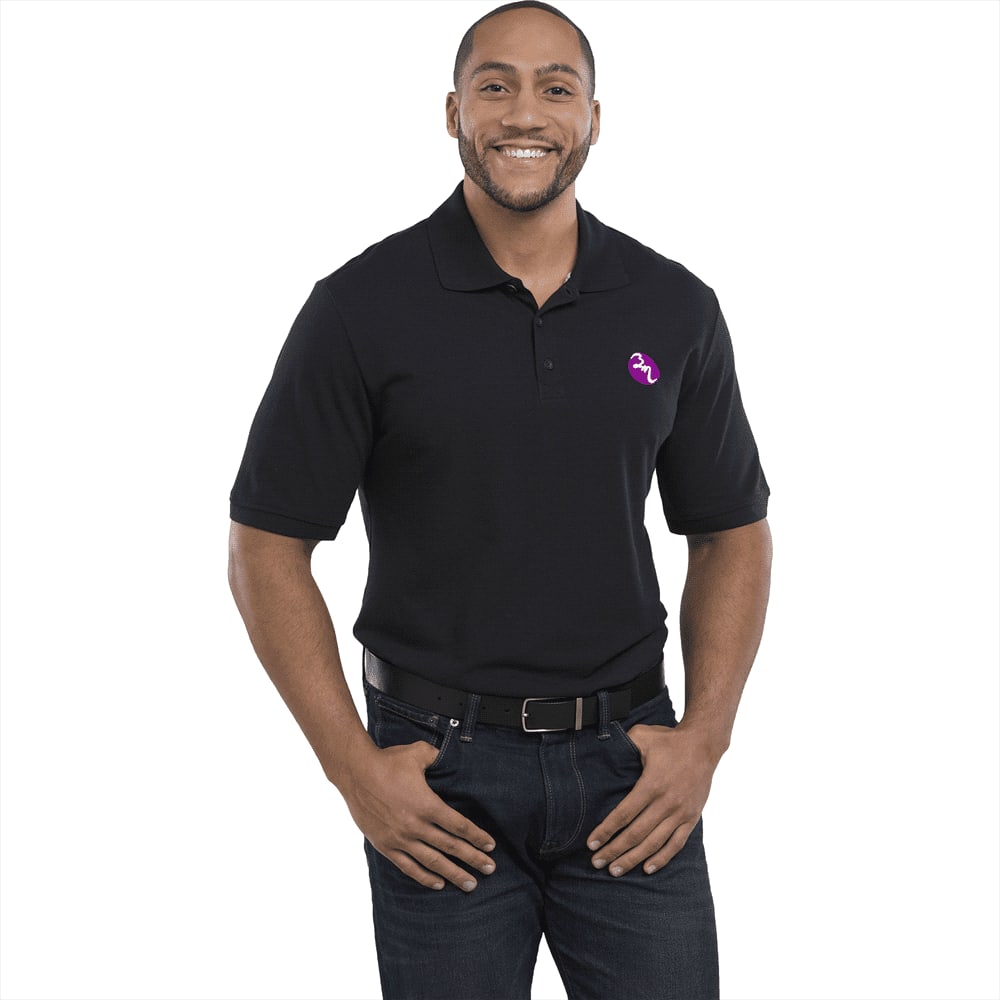 A man wearing a black short sleeve polo shirt with a logo on the chest, styled with jeans and a belt. Crandall Short Sleeve Polo - Mens - Image 1