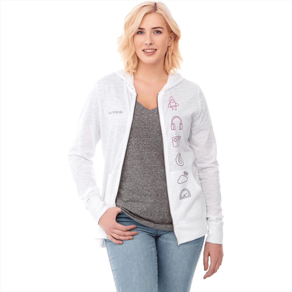 A woman wearing a white Garner Knit Full Zip Hoody, with a grey T-shirt and light blue jeans. The hoody features a logo. Garner Knit Full Zip Hoody - Womens - Image 1