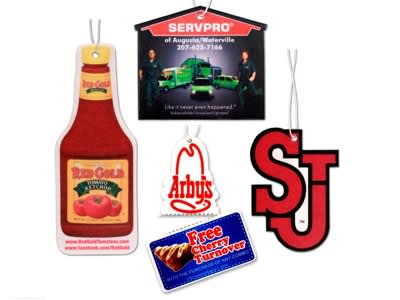 A collection of air fresheners in various shapes, including a ketchup bottle, a logo, and promotional tags in red and white. Air Fresheners - Image 1
