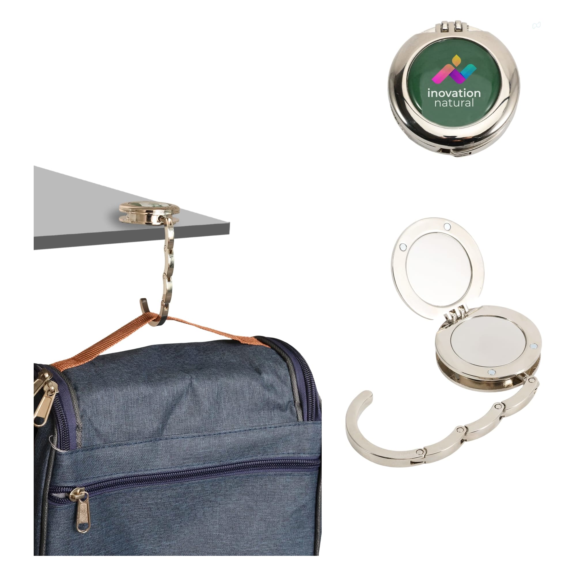 A foldable desk hook with a mirror, featuring silver metal and a logo, displayed with a backpack and attached to a table. Foldable Desk Hook with Mirror - Image 1