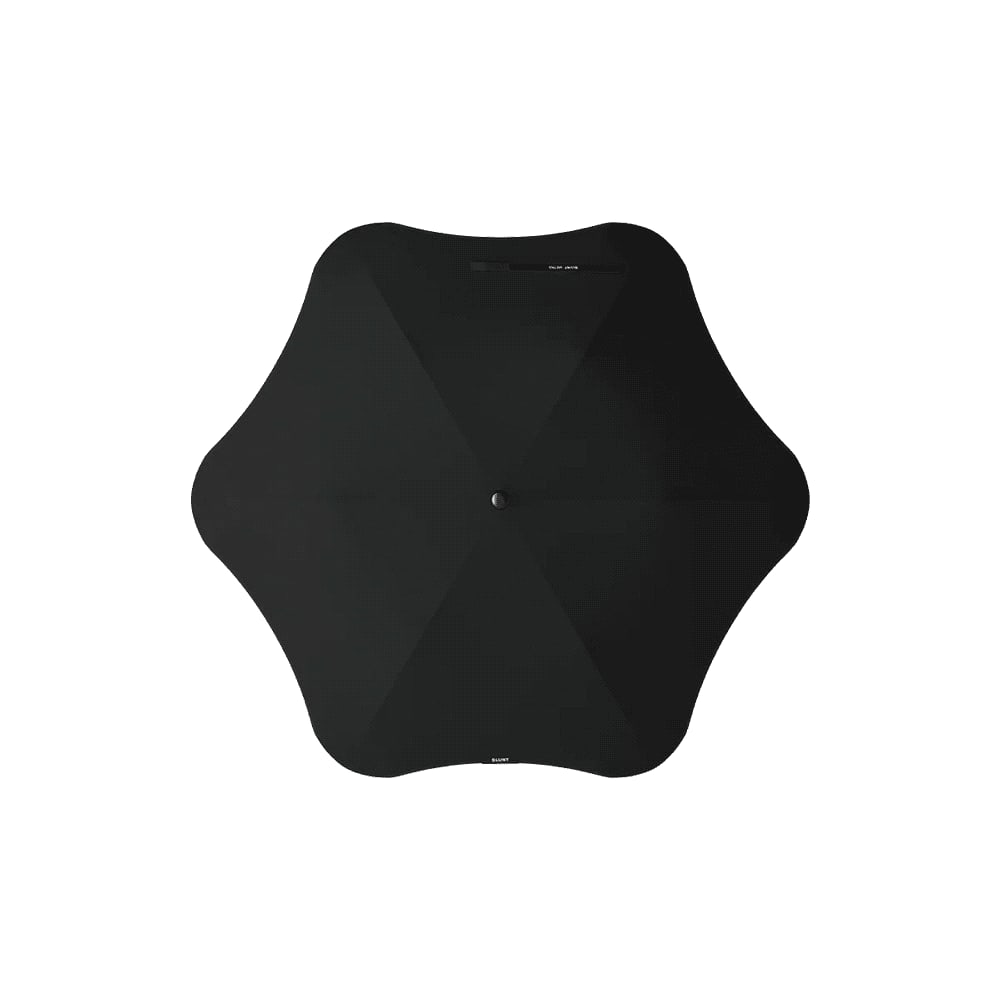 A black BLUNT Metro Umbrella with a unique shape and central button. It features a minimalist design. BLUNT Metro Umbrella - Image 1
