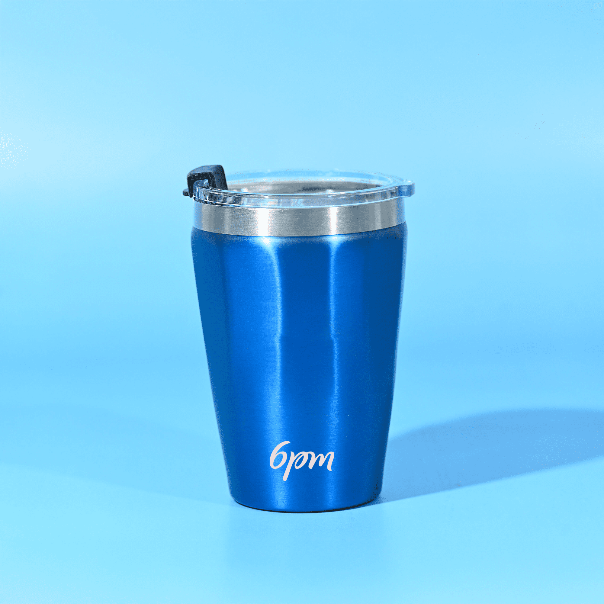 A drink tumbler with a sleek blue finish and silver rim, featuring a lid and a logo. Calypso 330ml Tumbler - Image 1
