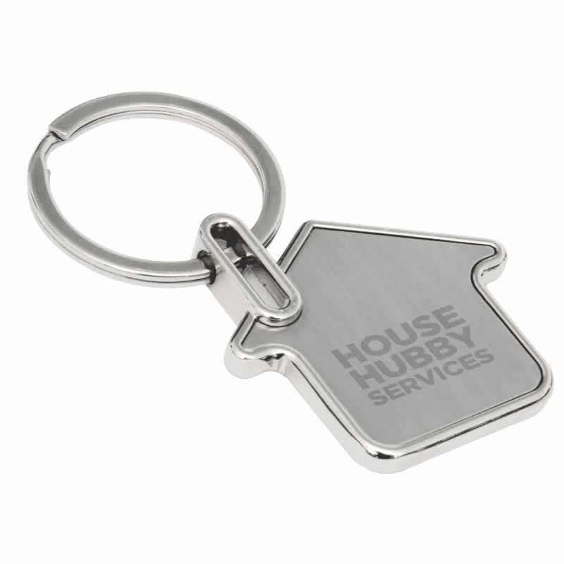 A silver house-shaped keyring with a metal loop and a logo. For Sale Keyring - Image 1