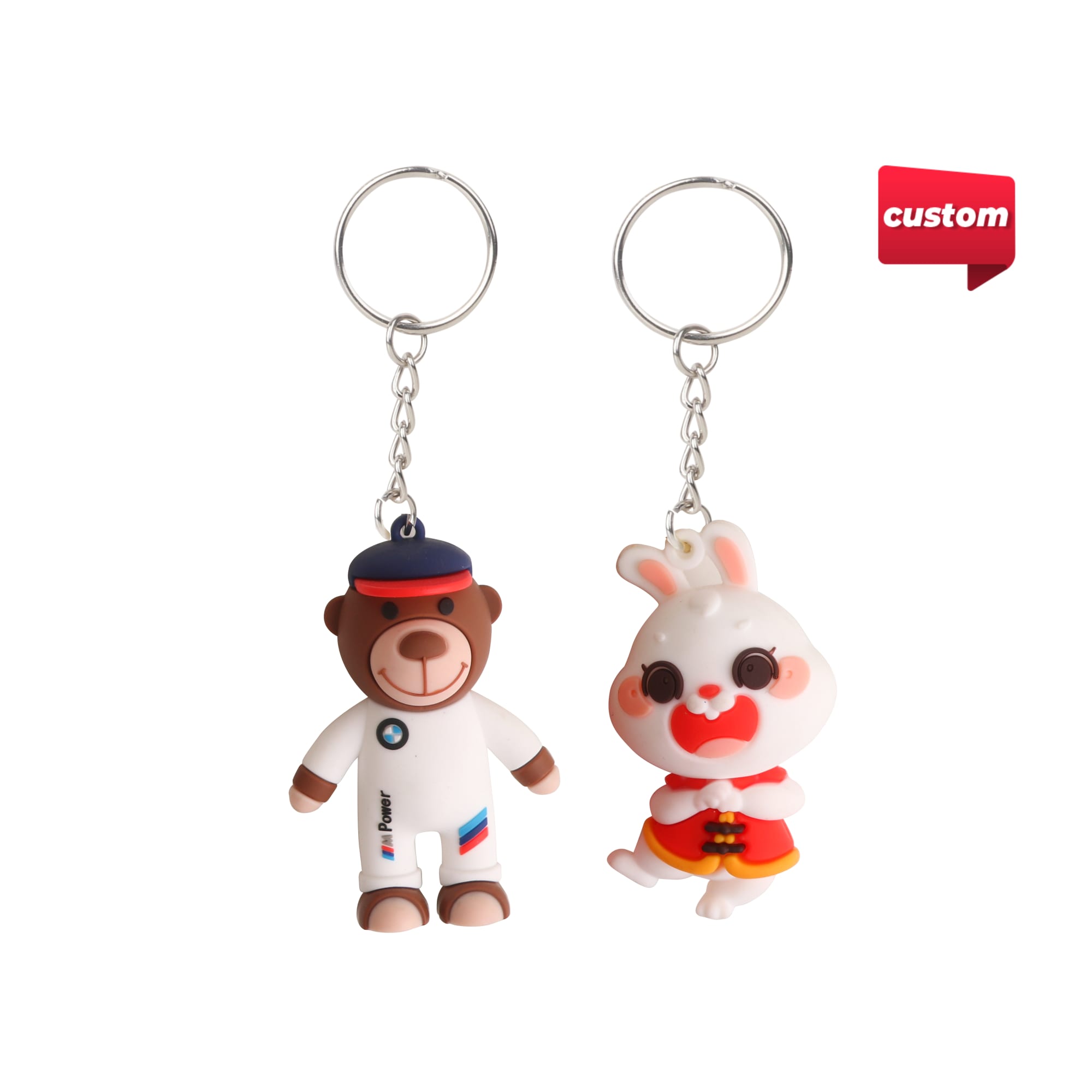 Two custom-shaped PVC keyrings, one depicting a bear in athletic gear and the other a cartoon rabbit, both with silver keyrings. Custom Shaped PVC Keyring - Image 1