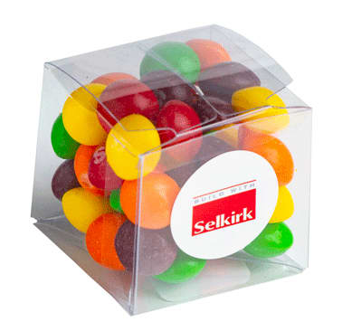 A transparent cube containing a mix of colourful Skittles, featuring yellow, orange, green, red, and purple candies. Cube with Skittles 60g - Image 1