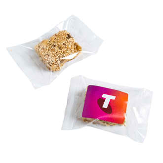 A sesame nut bar wrapped in clear packaging, featuring a golden-brown colour with a branded label. Sesame Nut Bar - Image 1