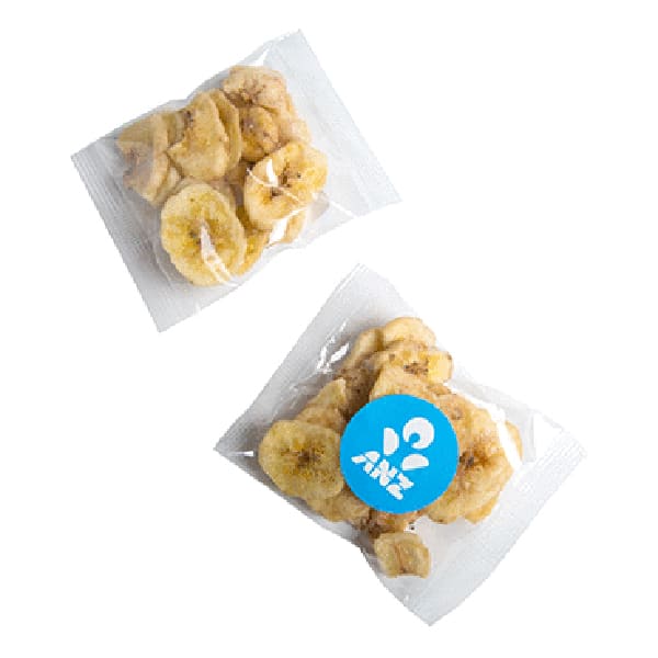 Two transparent packets of banana chips, featuring yellow slices of dried bananas and a logo on one packet. Banana Chips 25g - Image 1