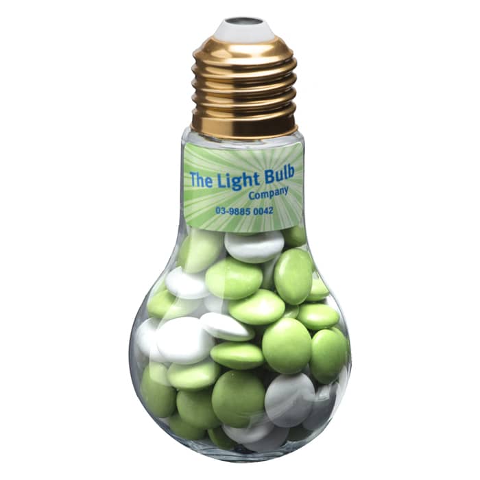 A light bulb-shaped container filled with green and white chocolate beans, featuring a gold-coloured top and a logo. Light Bulb with Choc Beans 100g - Image 1