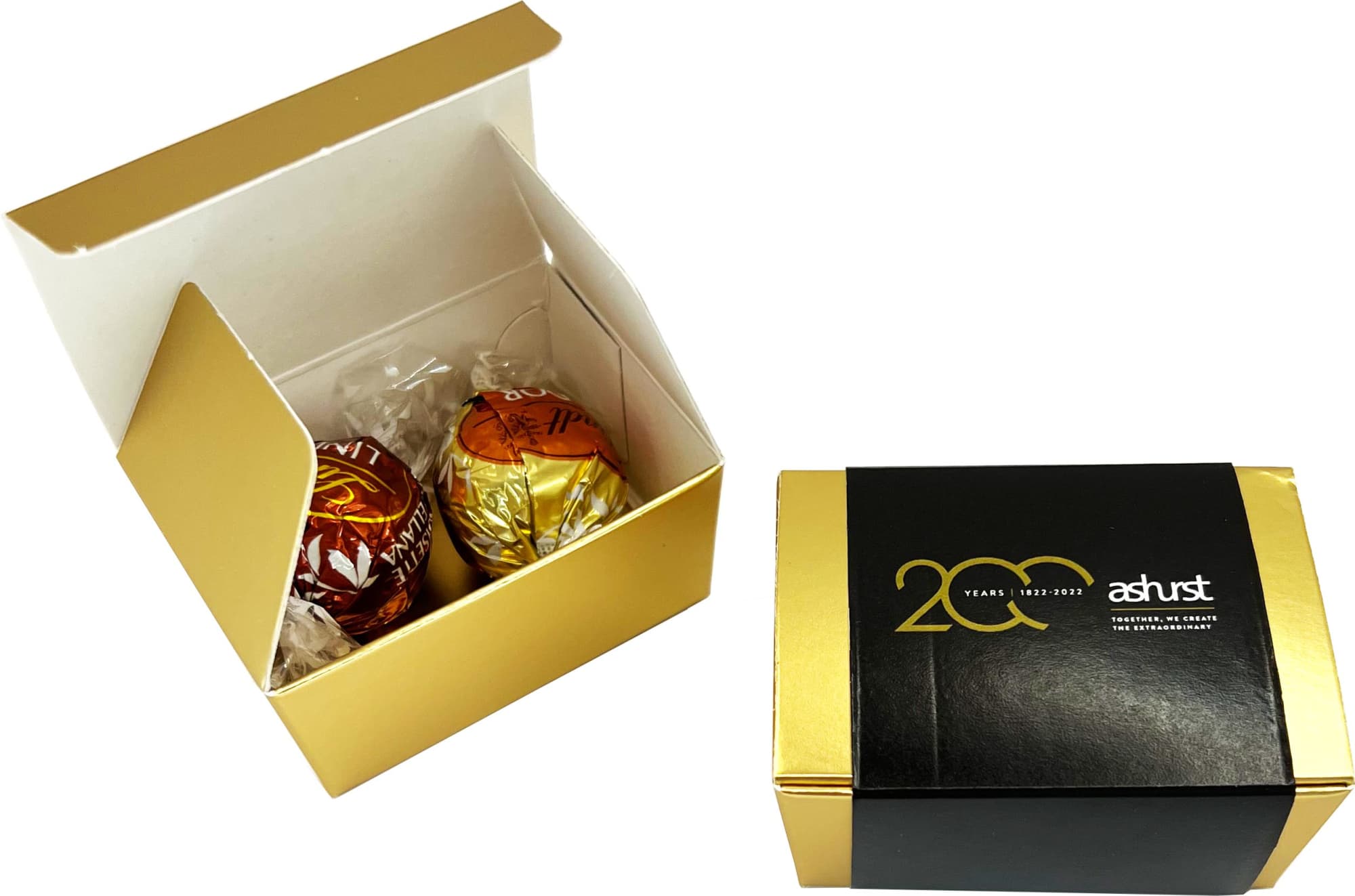 A gold and white box containing two chocolate balls, featuring branding on the exterior. 2 Pack Lindt Ball Choc Box - Image 1