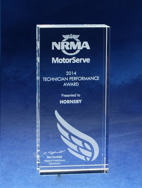 A clear optical crystal monolith award featuring etching, showcasing the NRMA logo and performance award details. Optical Crystal Monolith - With Etching - Image 1