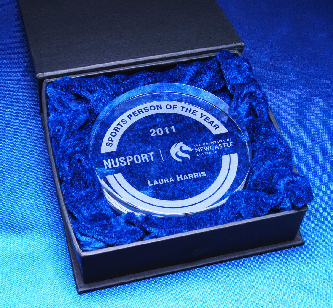 A crystal medallion in a black presentation box, surrounded by blue cushioning material. Optical Crystal Medallion 90mm In Presentation Box - Image 1