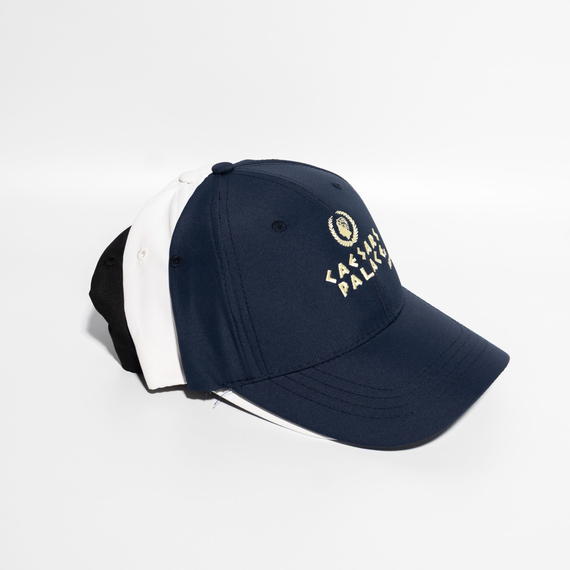 A navy blue and white baseball cap with a Velcro strap, featuring a logo on the front. Promo Poly-Cotton 6 Panel Velcro Strap Baseball Cap - Image 1