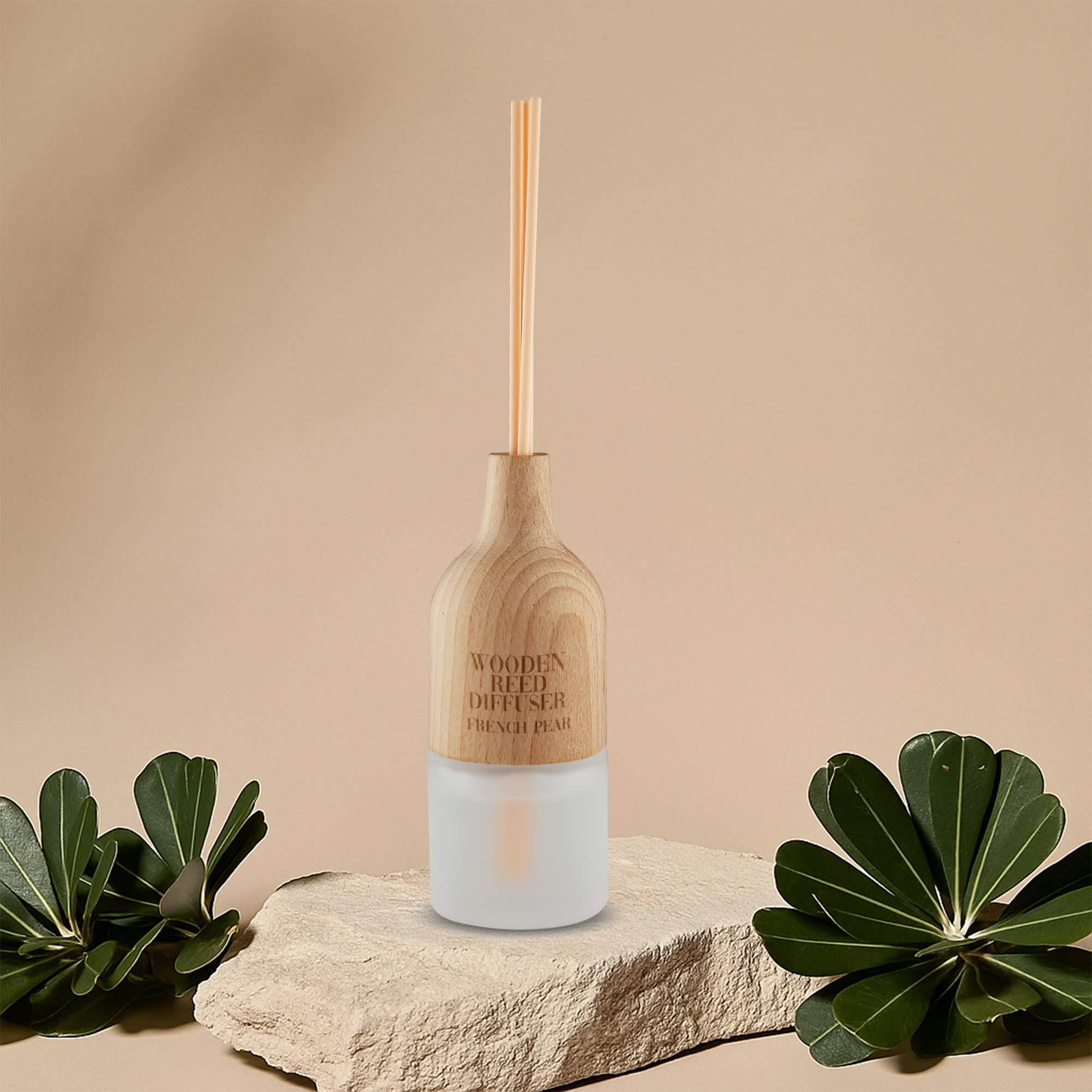 A wooden reed diffuser with a light wood top and a frosted glass base, displayed on a stone surface with greenery. Wooden Reed Diffuser – 30ml - Image 1