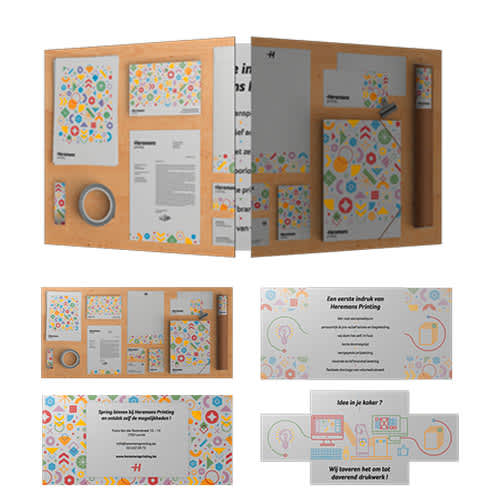 A collection of stationery items on a wooden board, featuring colourful patterns and various papers, including a binder and envelopes. Magic Loop DL - Image 1
