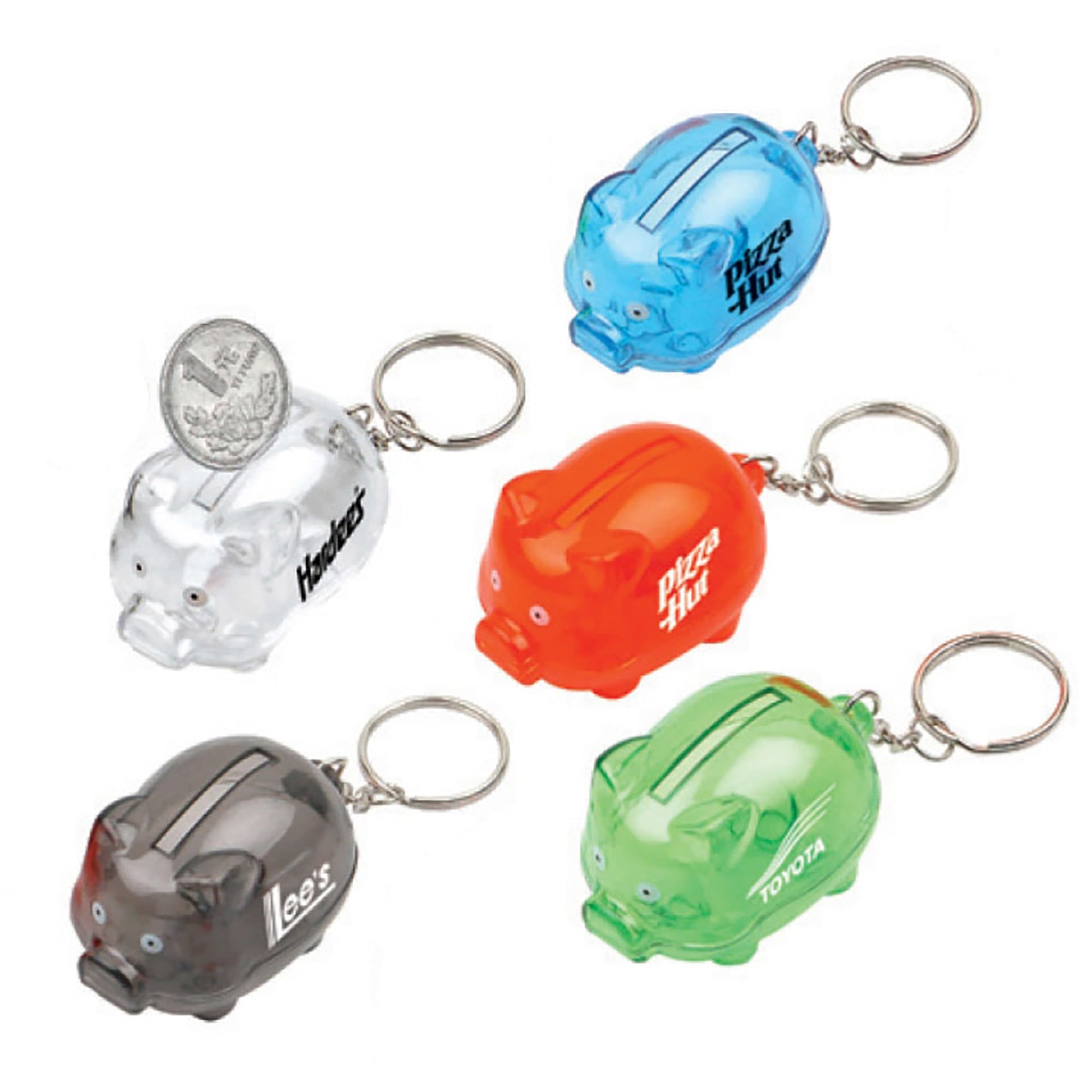 A set of mini piggy bank keyrings in clear, orange, green, and two opaque colours, featuring various logos. Coin Bank with Keyring - Image 1