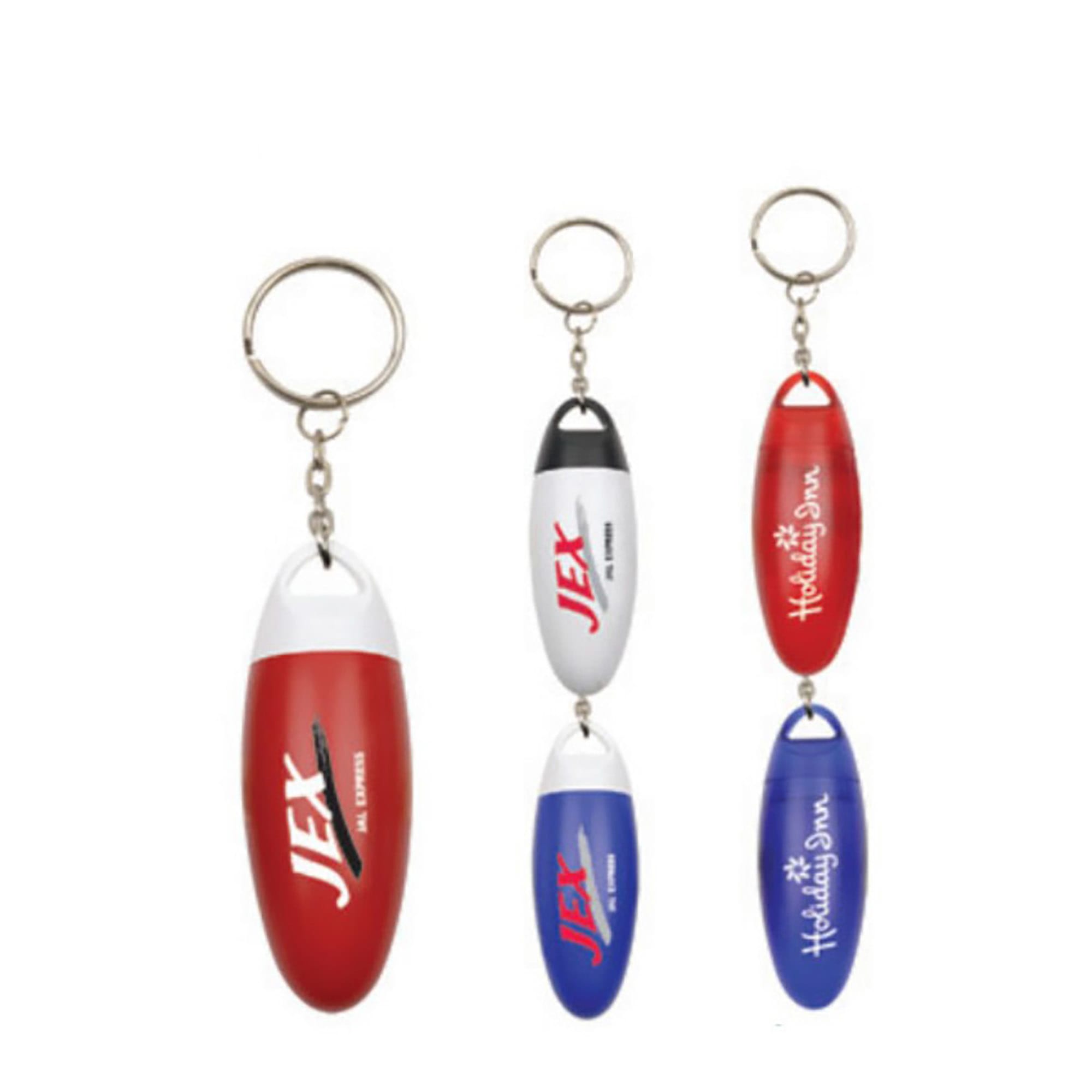 A set of four pill box keychains in red, white, and blue, featuring various logos and keyring attachments. Pill Box - Image 1