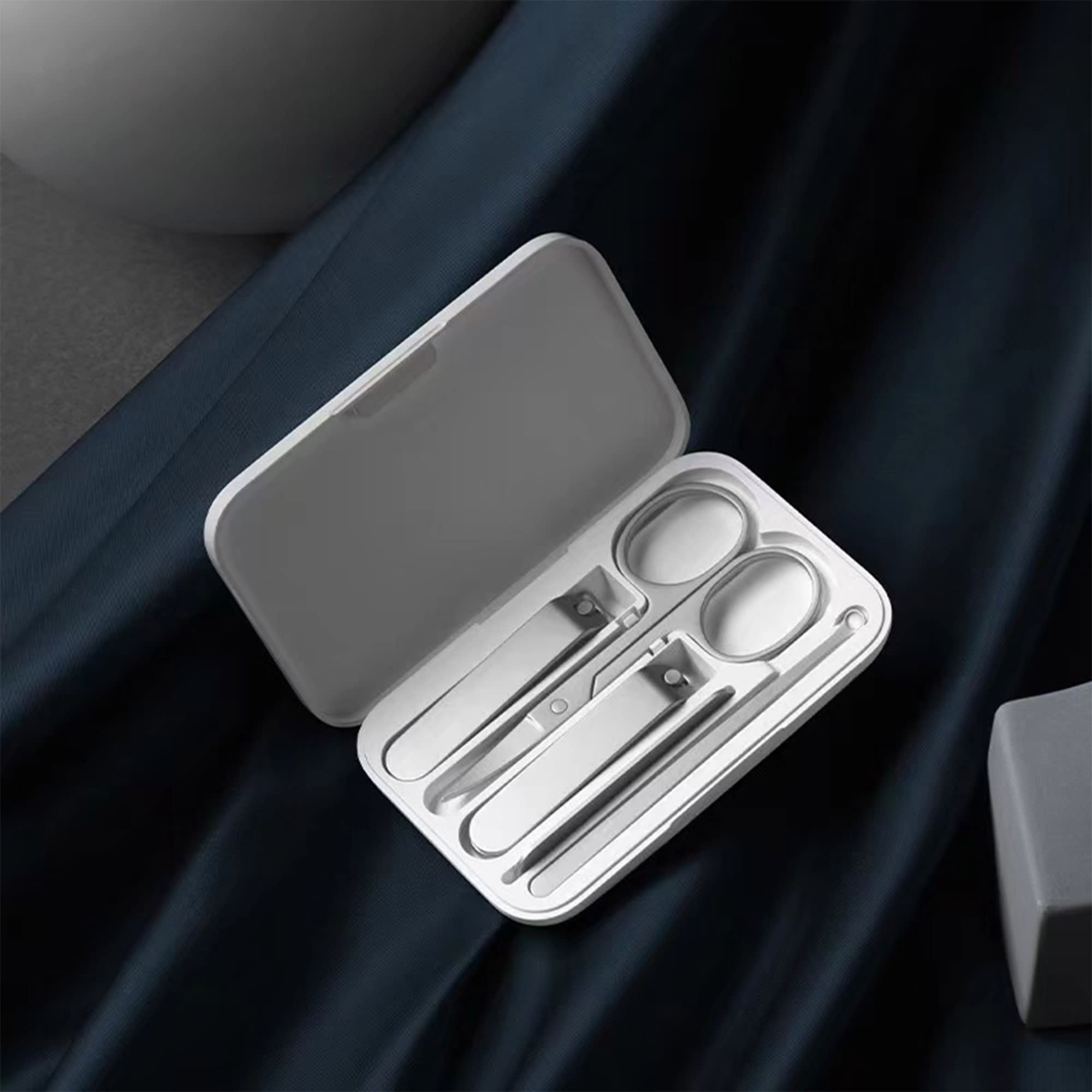 A manicure set with silver metal tools, housed in a sleek white case. Manicure Set - Image 1