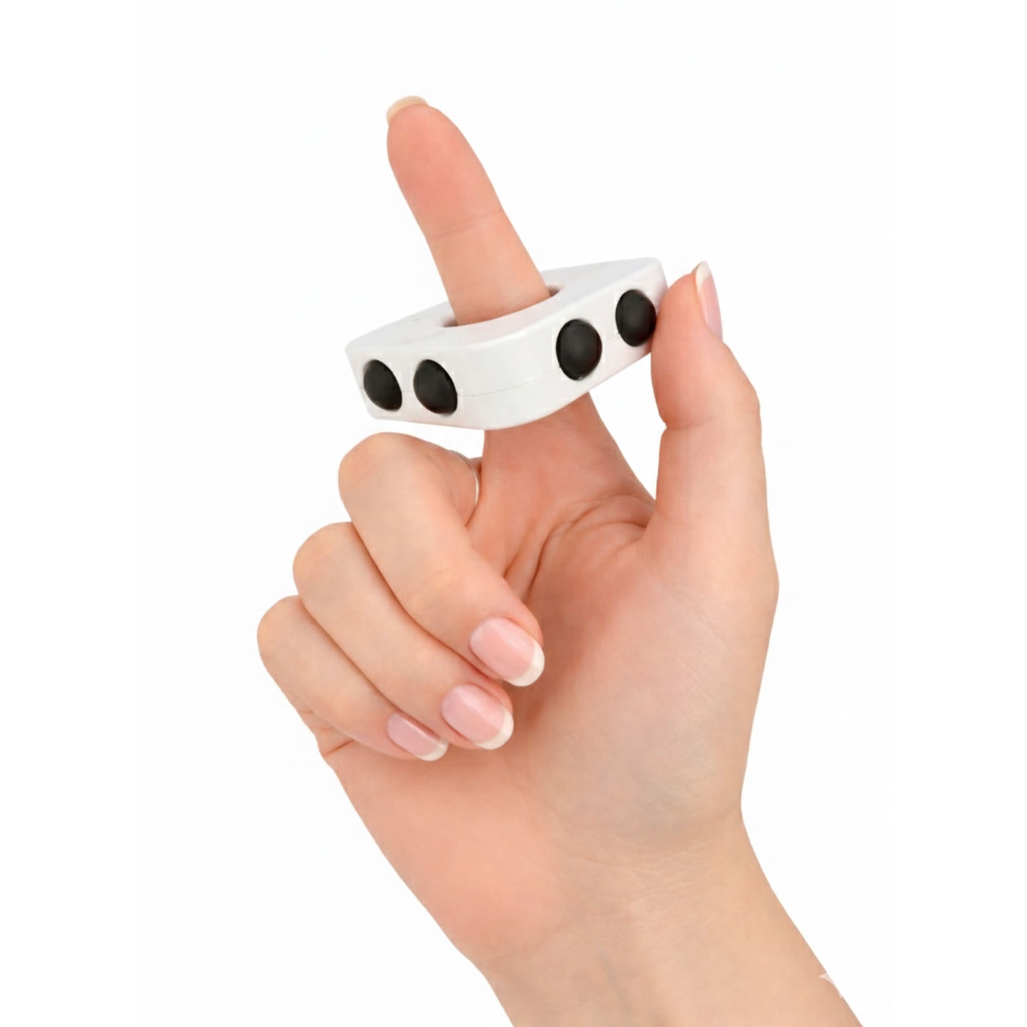 A white finger spinner held between fingers, featuring three black buttons on its surface. Decompression finger spinner - Image 1
