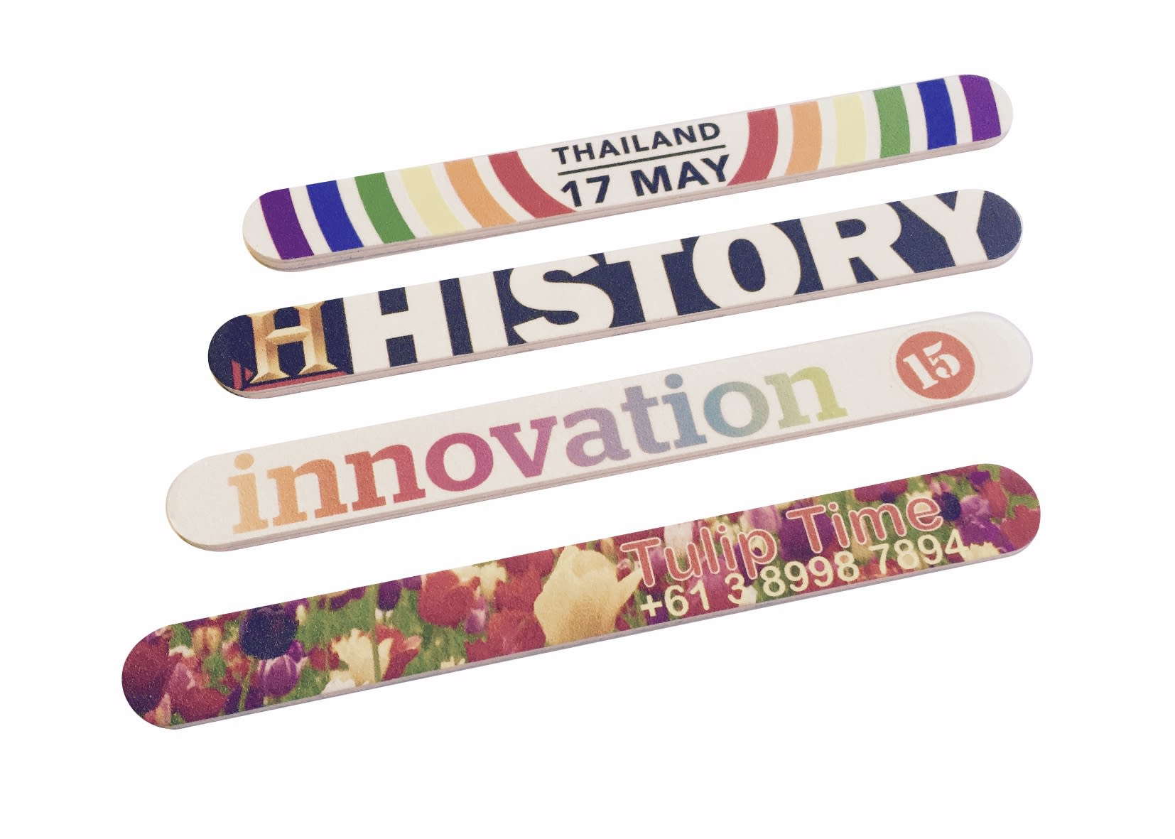 Four colourful nail files with various designs, including floral patterns and text. Each file features unique branding. Linda Nail File - Image 1