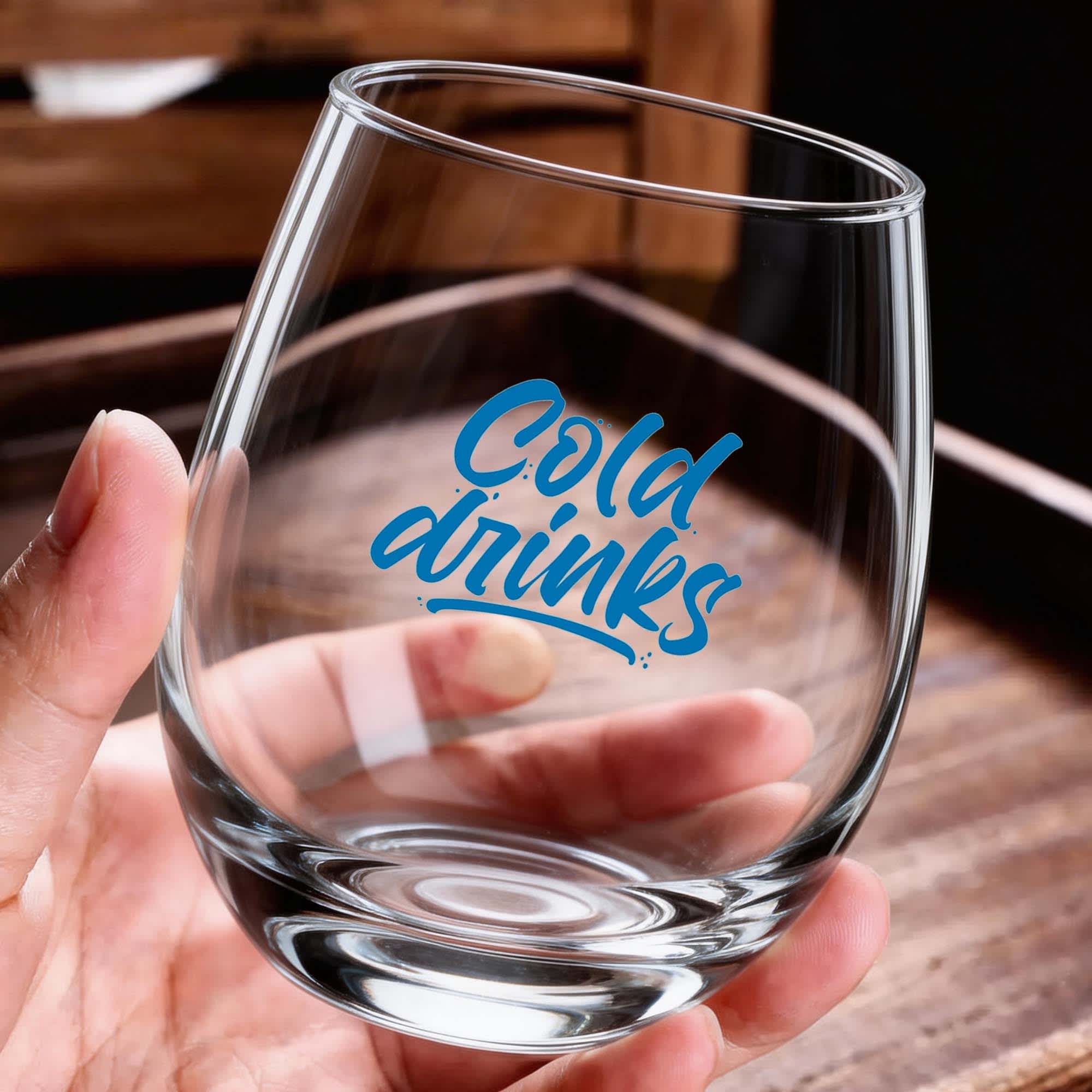 A glass wine tumbler with a clear design and a logo featuring the words "Cold drinks" in blue. Phil Glass Cup 535ml - Image 1