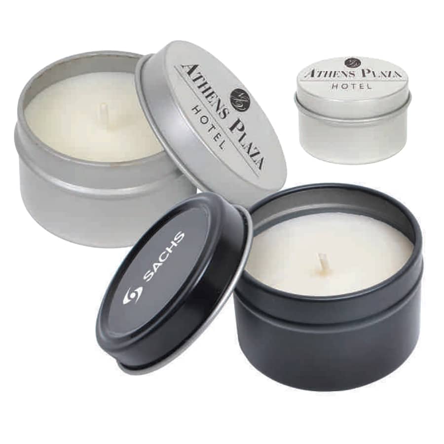 A set of vanilla scented candles in silver and black tin containers, featuring various logos on the lids. Vanilla Scented Candle - Image 1