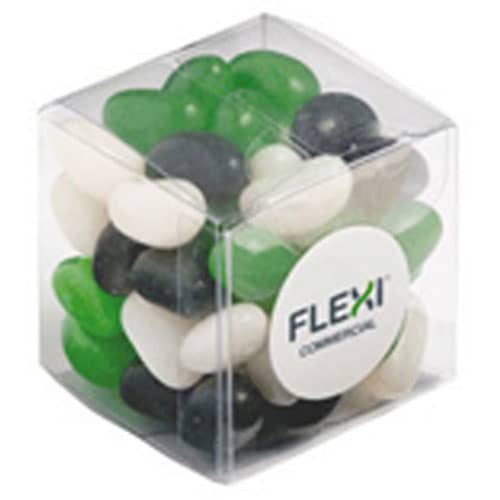 A cube container filled with green, black, and white jelly beans. The container has a logo on it. Cube with Mini Jelly Beans 60g - Image 1