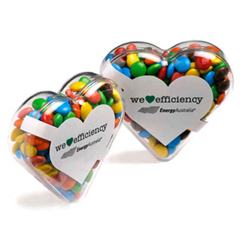 Acrylic heart-shaped container filled with colourful M&Ms, featuring a logo on the front. Acrylic Heart with Mini M&Ms 50g - Image 1