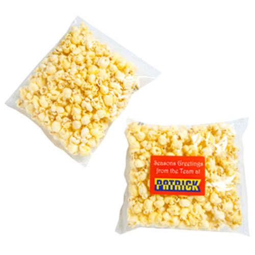 A clear bag containing yellow buttered popcorn, featuring a logo on the packaging. Buttered Popcorn 50g - Image 1