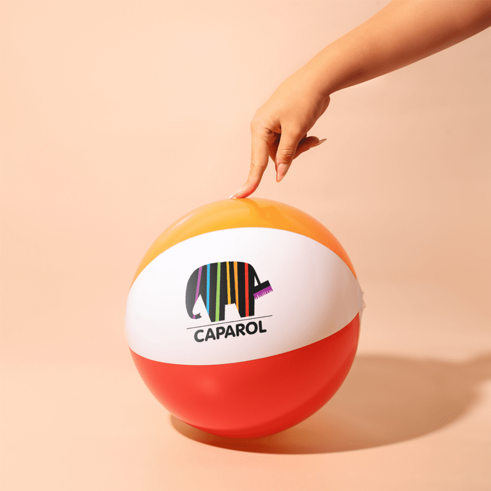 A beach ball in orange, white, and red with a logo, being held by a hand. Mornington Beach Ball - Image 1