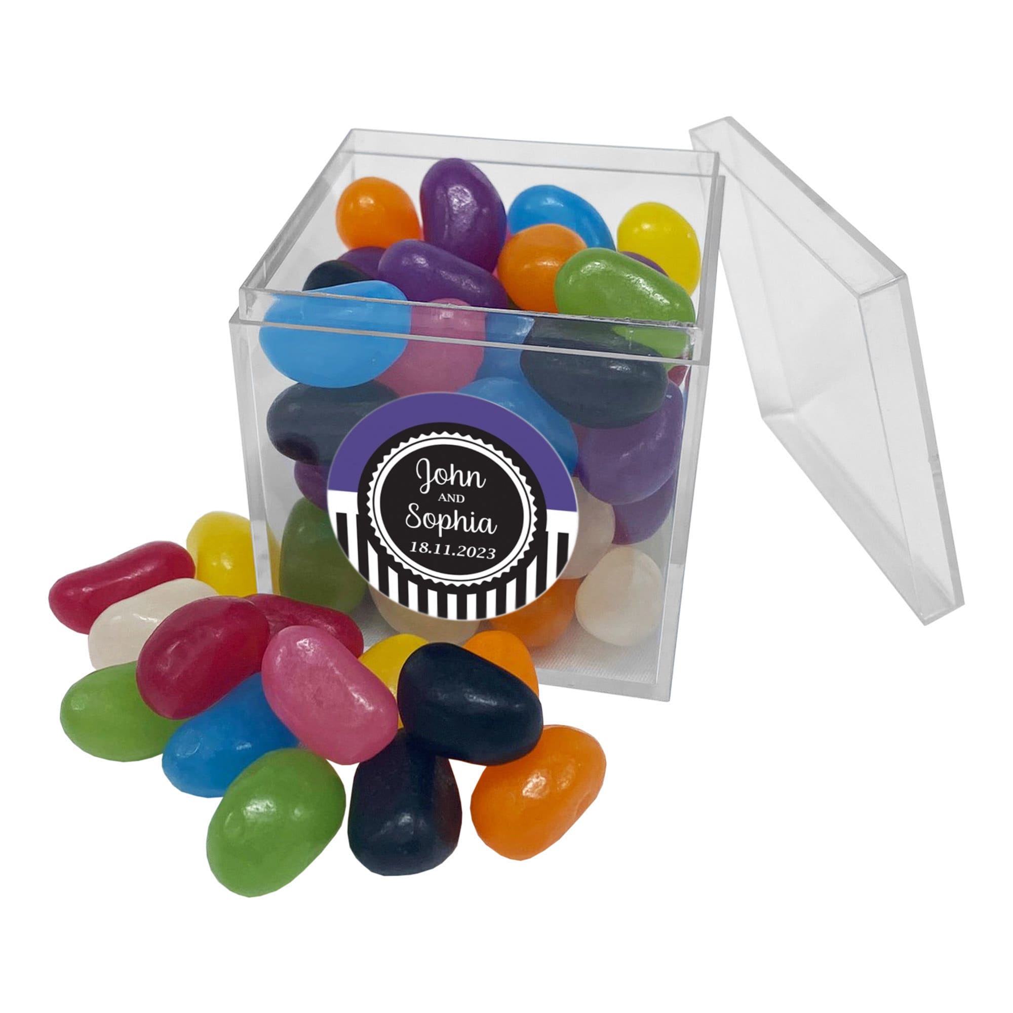 A clear cube filled with colourful jelly beans in various shades, with some scattered around it. Jelly Bean In Cube 50g - Image 1