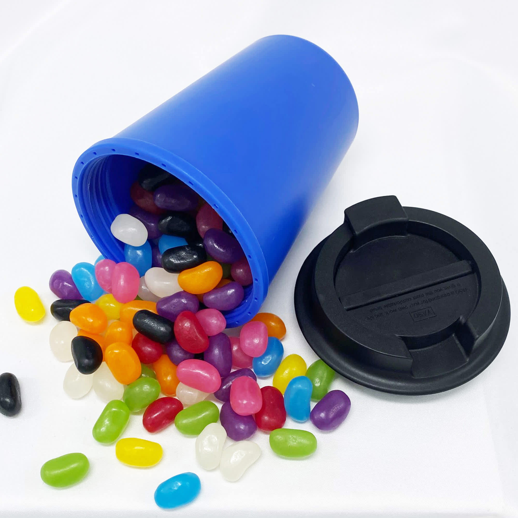 A drink bottle in blue with a black lid, surrounded by colourful jelly beans in various shapes and sizes. Jelly Bean In Karvo Cup - Image 1