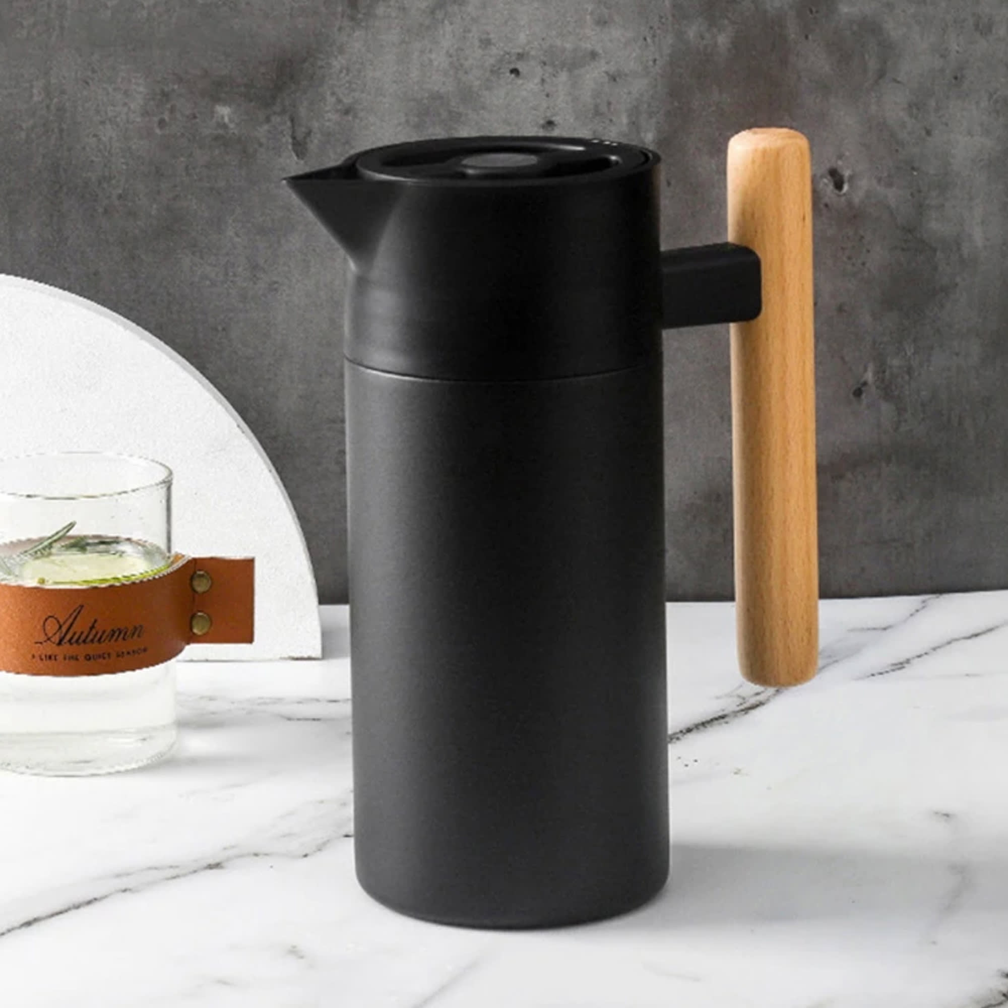 A drink bottle with a sleek black finish and a wooden handle, featuring a spout and a minimalist design. Avanti Jug - Image 1