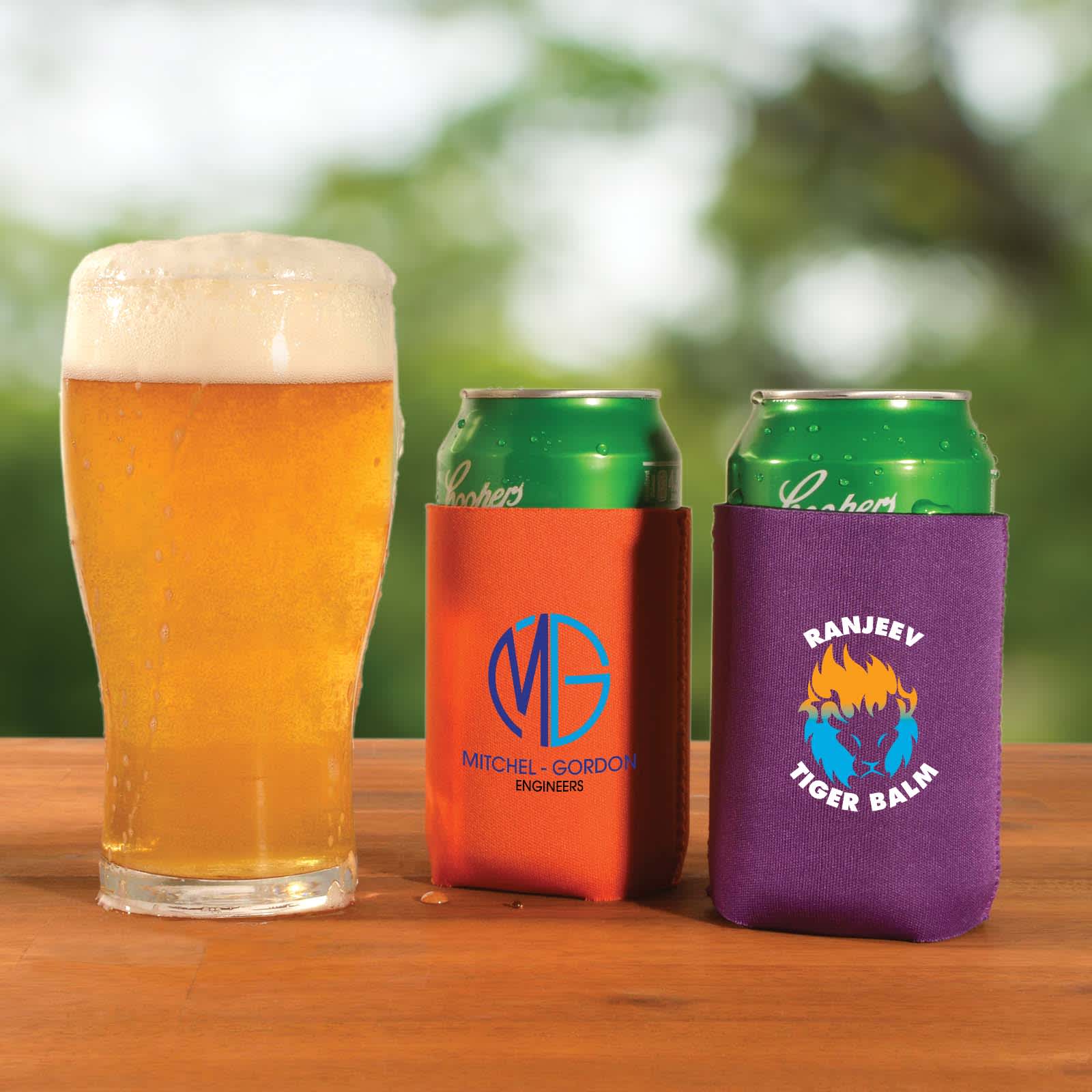 A drink cooler in orange and purple holds cans, with a beer glass nearby. Both coolers feature different logos. Surf Stubby Cooler - Image 1