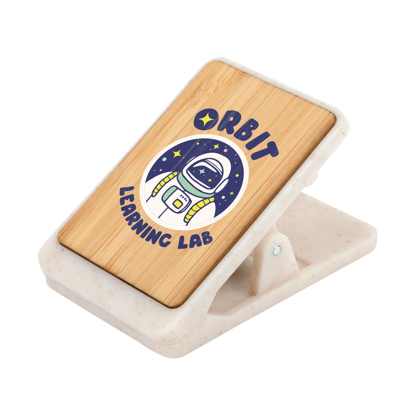 A bamboo magnetic clip with a design featuring an astronaut surrounded by stars, set on a speckled white base. Mako Magnetic Clip - Image 1