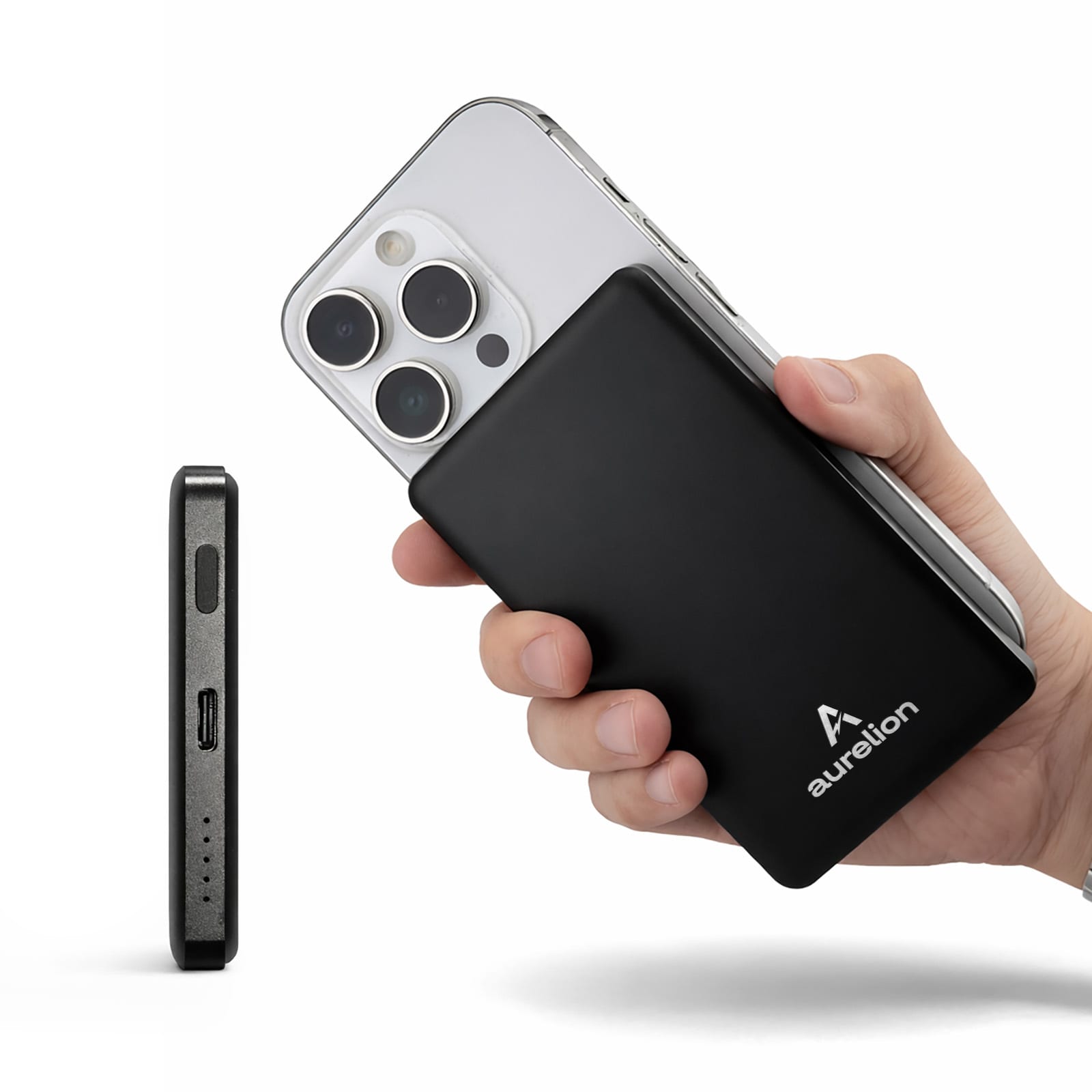 A power bank in black is held alongside a smartphone, showcasing its slim design and branding. Axial 5,000mAh Solid State Power Bank by Nomis - Image 1