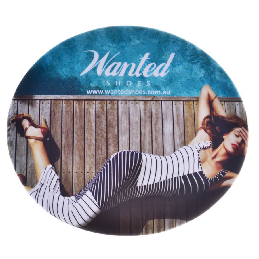 A round mouse mat featuring a woman in a striped dress lying on a wooden surface, with a logo at the top. Rubber Sponge Mouse Mat - Image 1