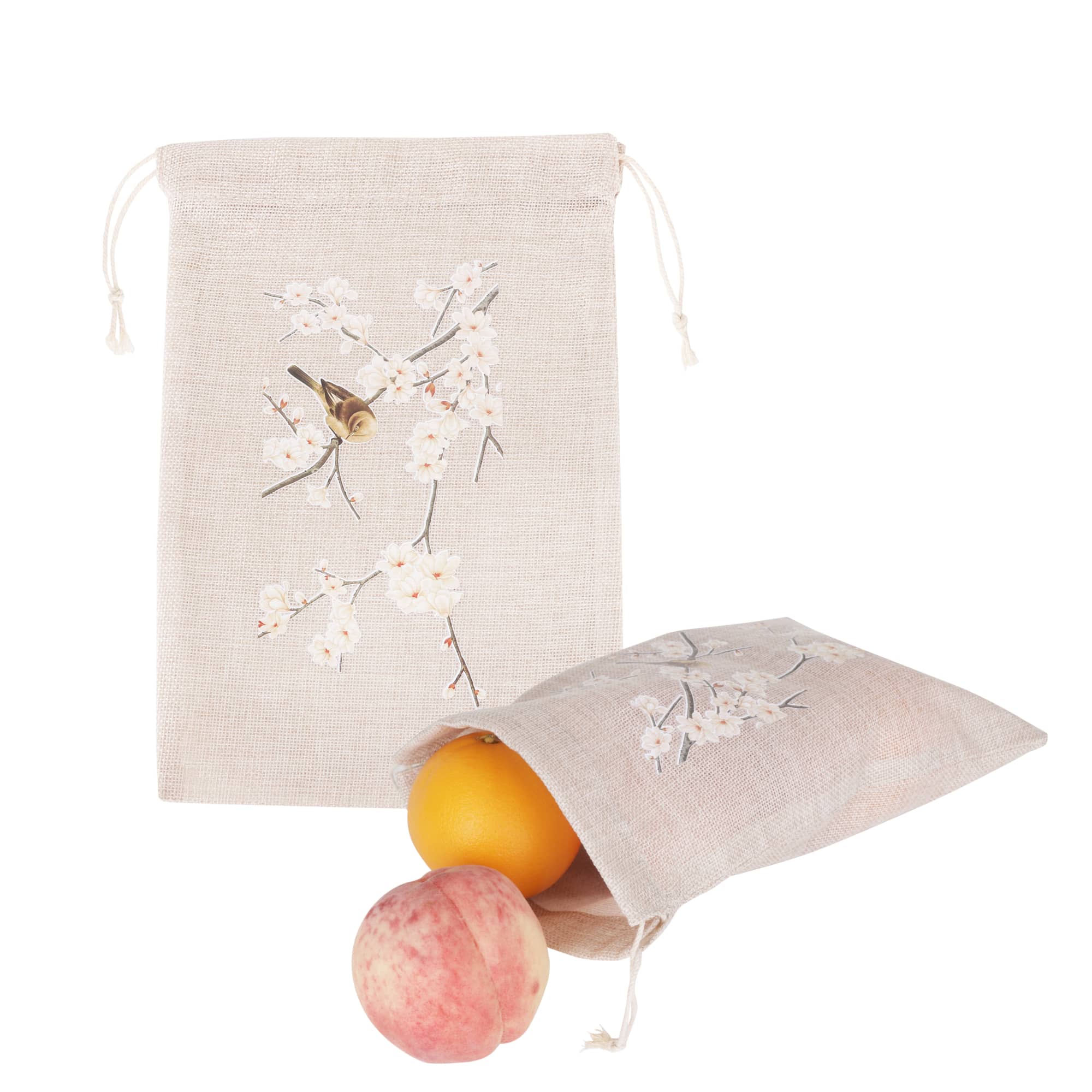 A large jute produce bag in natural colour, featuring floral designs, filled with oranges and a peach. Large Jute Produce Bag - Image 1