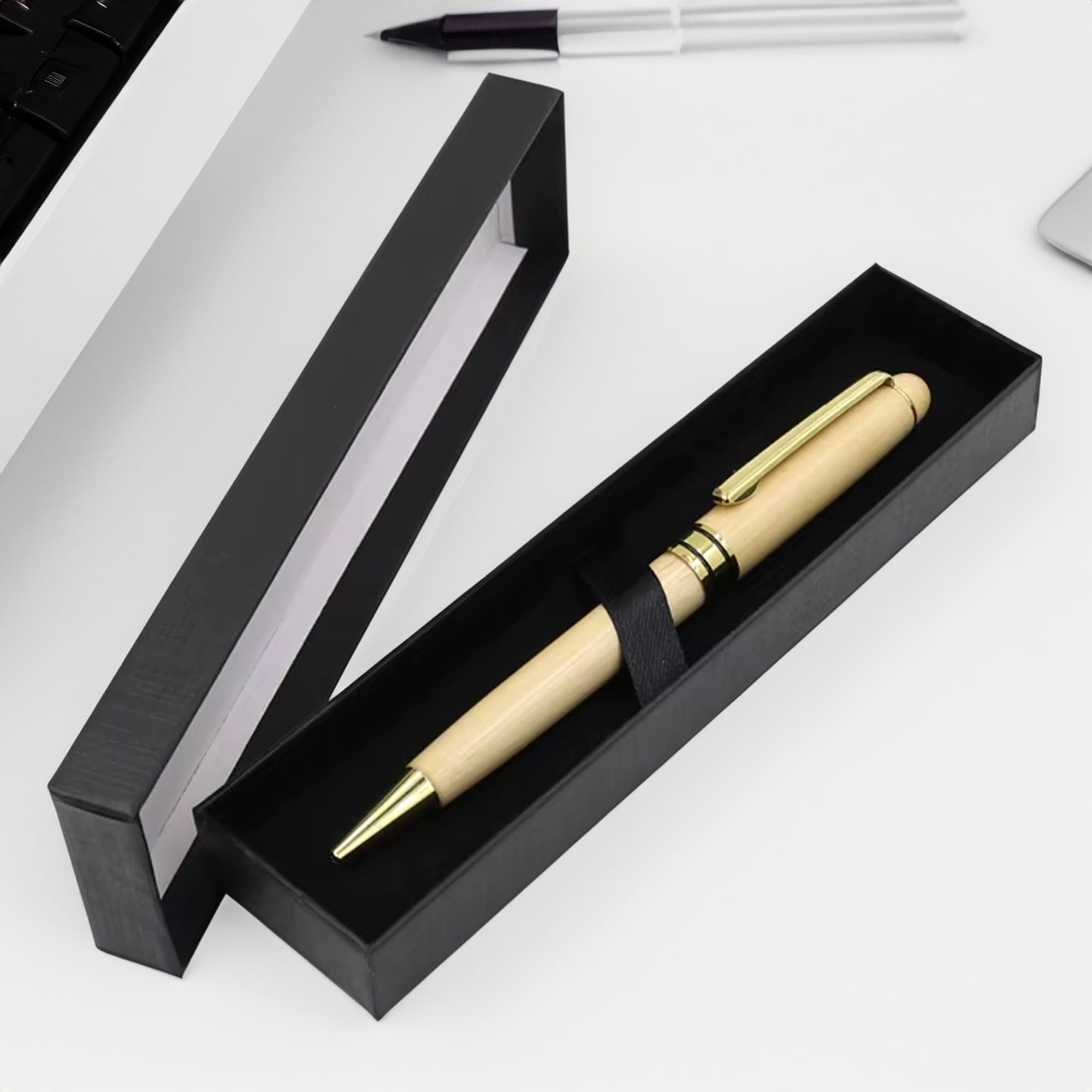 A wooden pen with gold accents in a sleek black presentation box. The box is open, revealing the pen inside. Single Presenter - Image 1